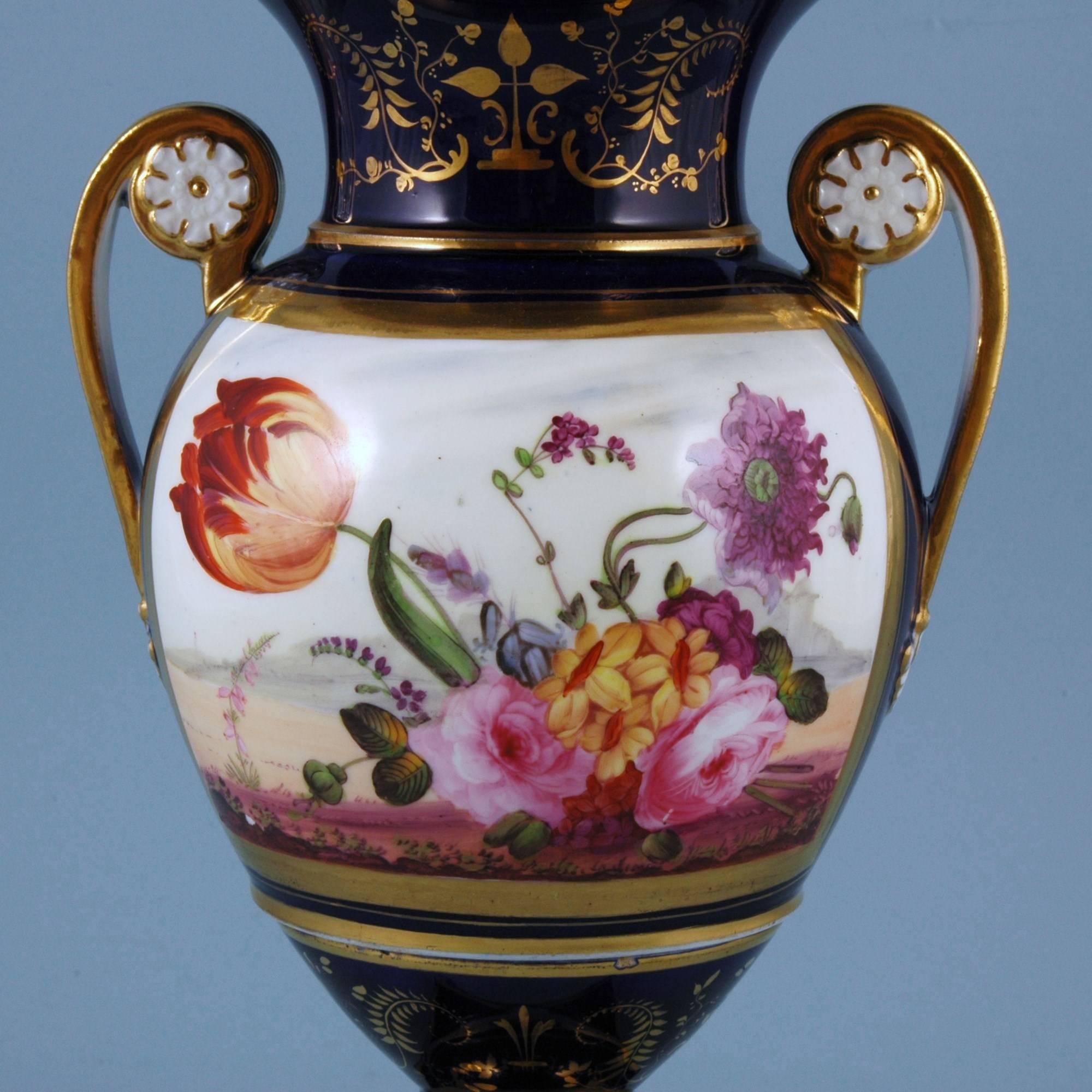 English porcelain botanical blue ground vase,
Coalport,
circa 1825

The Coalport porcelain vase is painted with a large central panel of flowers including a tulip on a blue ground which is highlighted in gold.
 