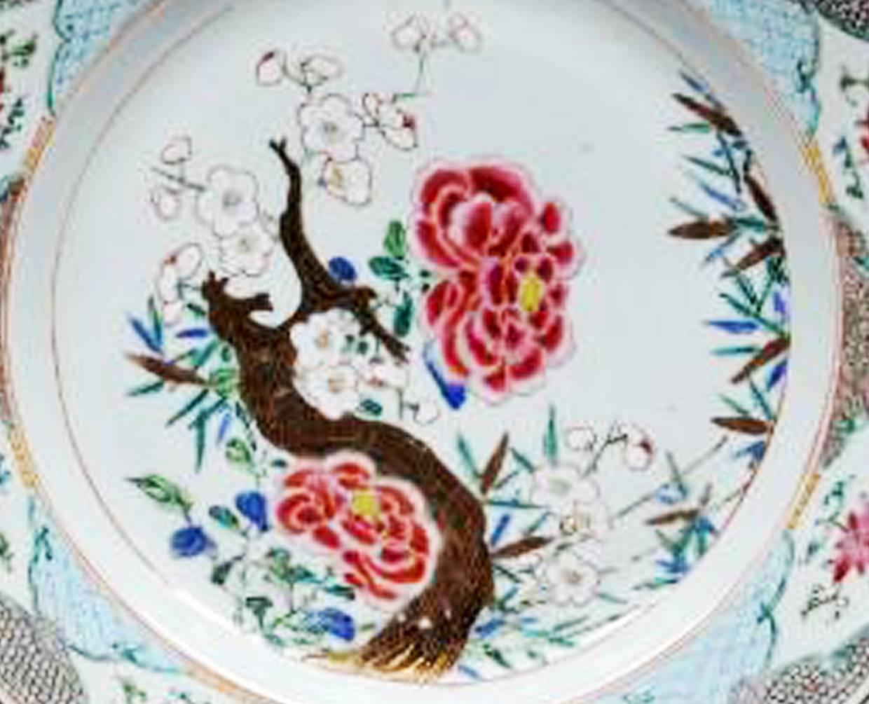 Chinese Export famille rose porcelain dishes, 
circa 1765-1775.

The pair of Chinese Export famille rose large dishes are finely painted with a flowering branch design with two large red flowers and a branch with blooming small white flowers. The