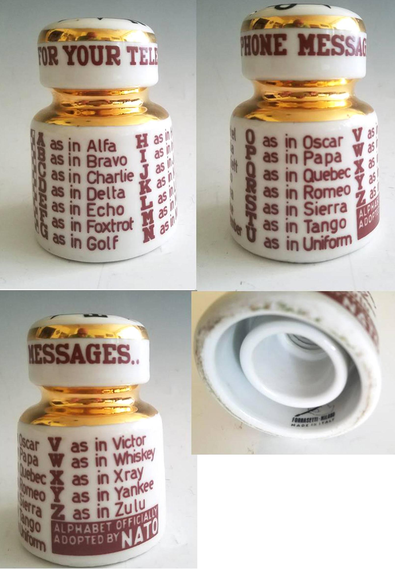 Piero Fornasetti NATO Call Letters paperweight in form of an electrical insulator,
1950s.

This is a great and rather rare piece from Italian designer Piero Fornasetti's line of ceramic insulators, cleverly repurposed into paperweight pen rests