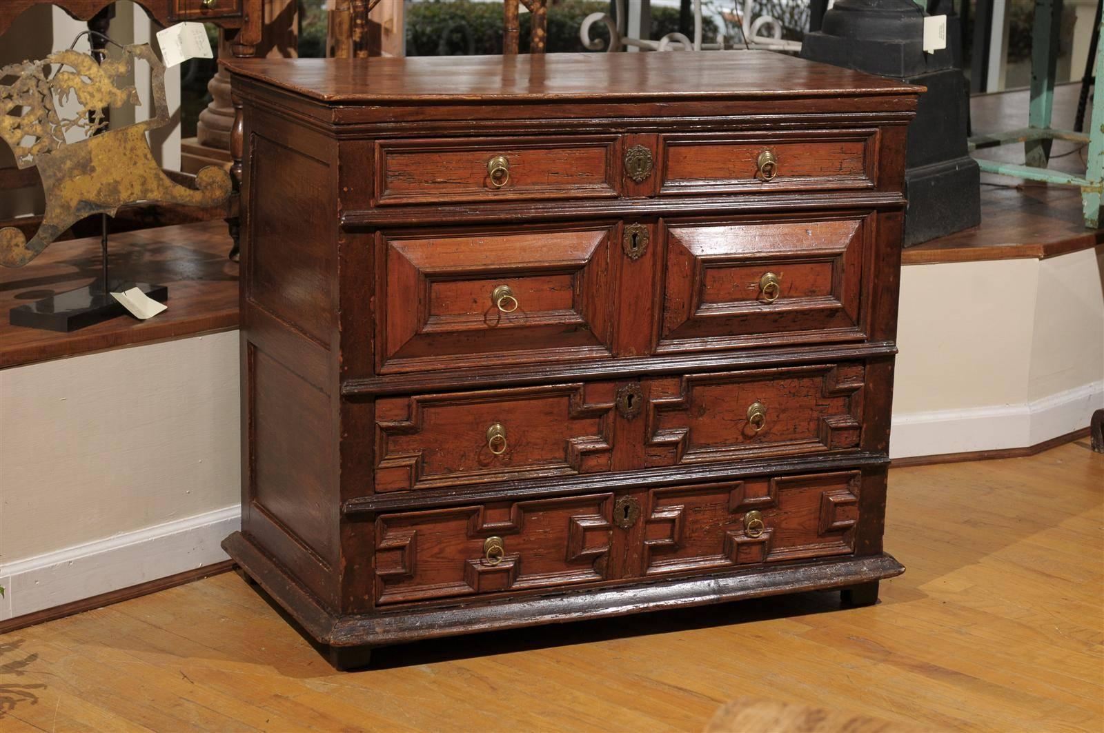 This chest is very unusual because most Jacobean chest are in oak and this is pine. It has four drawers. Each has different carved motifs which is typical of the style. The hardware is original to the chest. The color is very warm and it would fit