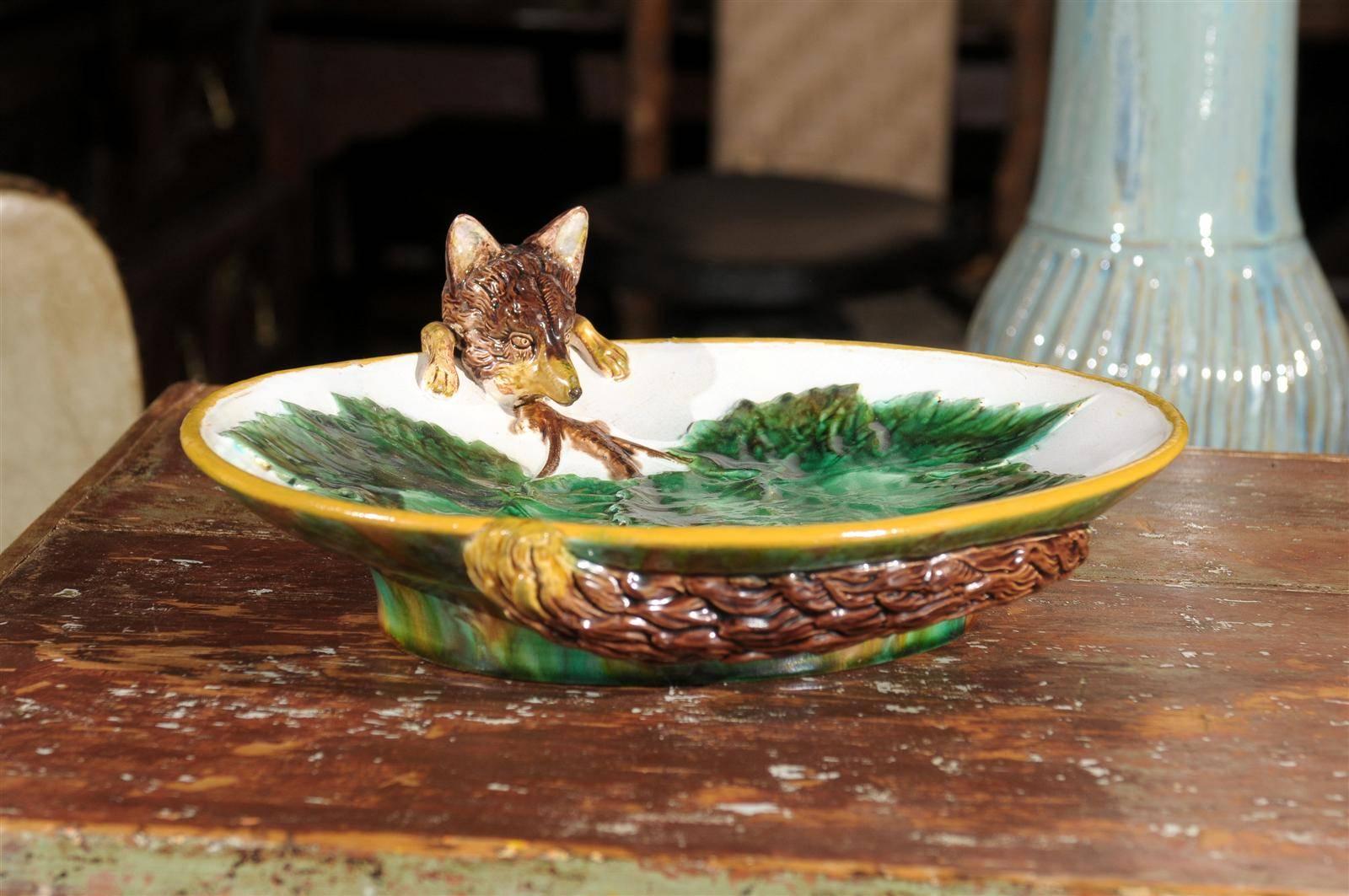 This is a perfect and lovely example of George Jones Majolica. The fox appears on quite a few of his pieces. The fox tail is wrapped around the bottom of the dish. It was probably inspired by Aesop's fables. George Jones worked for the Minton