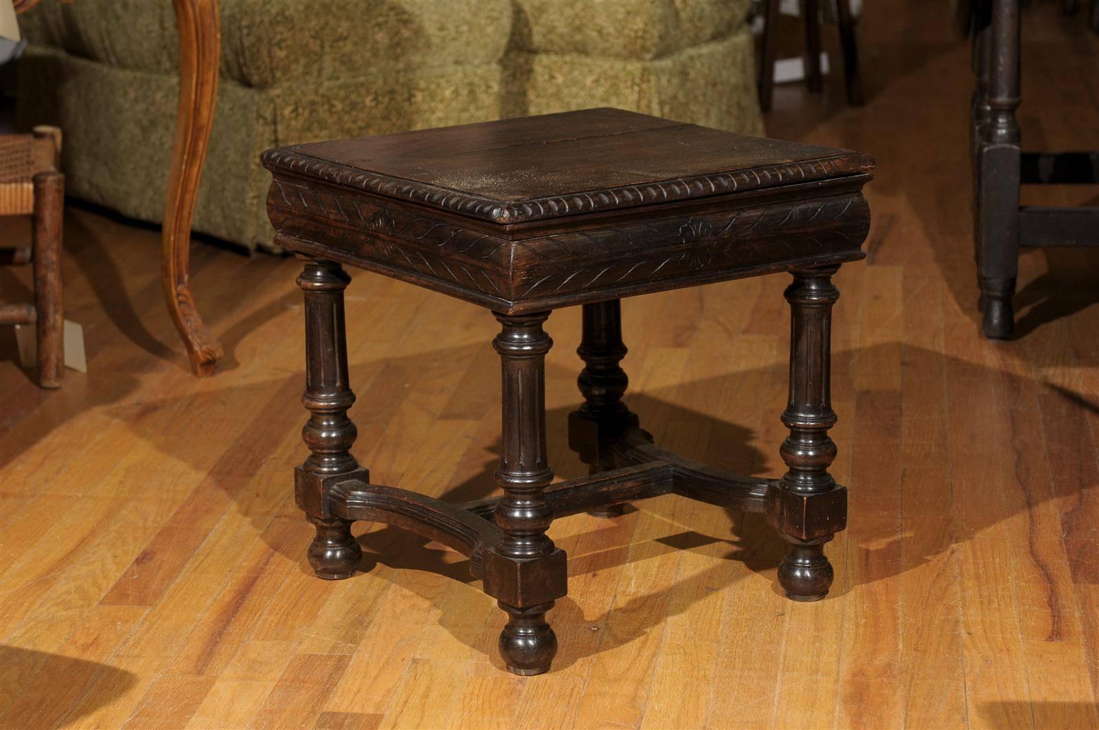 This English, 19th century, wooden stool has a solid wooden top and turned legs. There are incising marks on the ogee edge and also on the apron. This stool would be great in front of your fireplace or as a table beside your chair.

