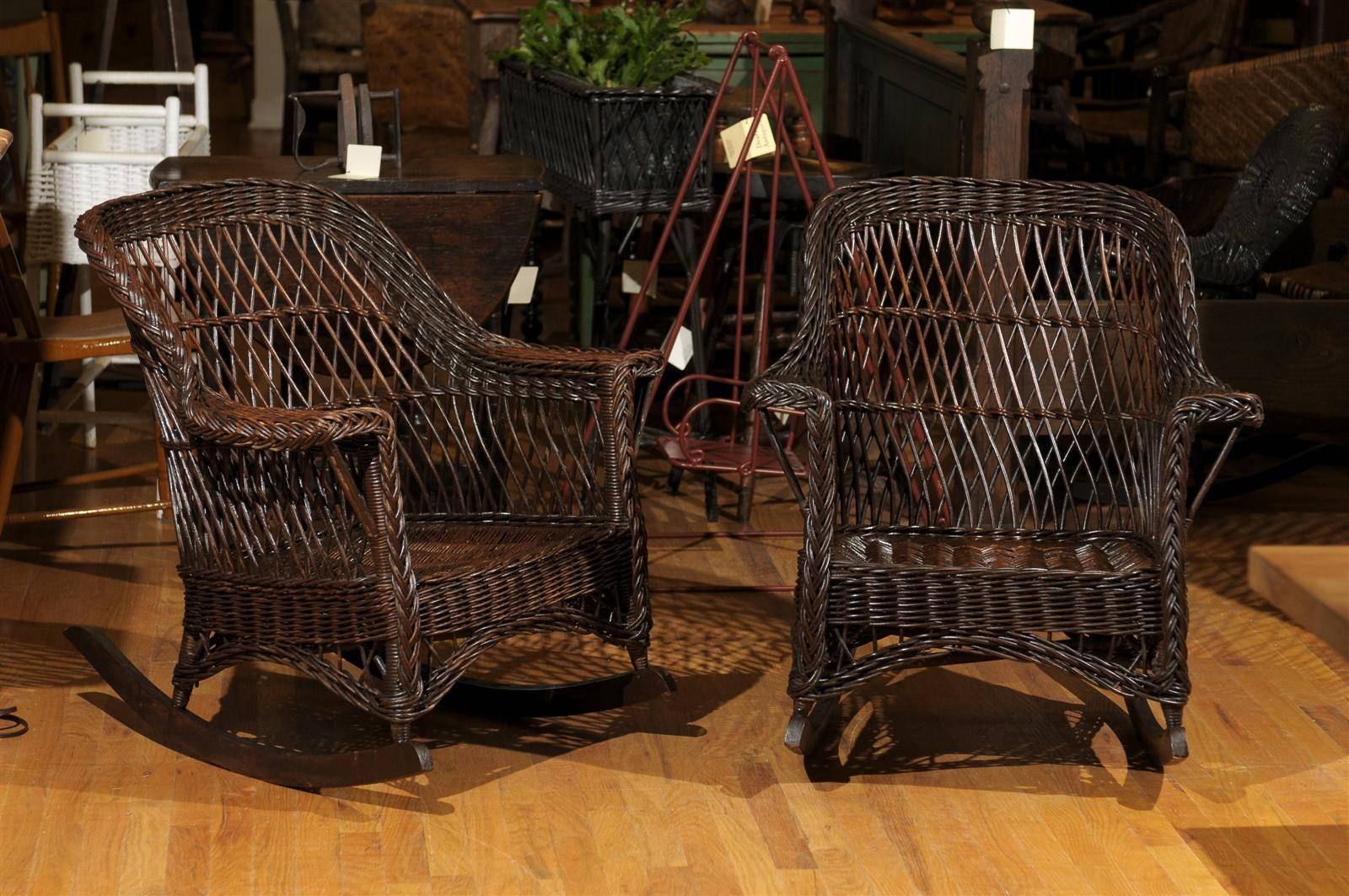 This Bar Harbor style pair of Heywood-Wakefield wicker rockers is signed and naturally woven. This pair of rockers is stained brown.