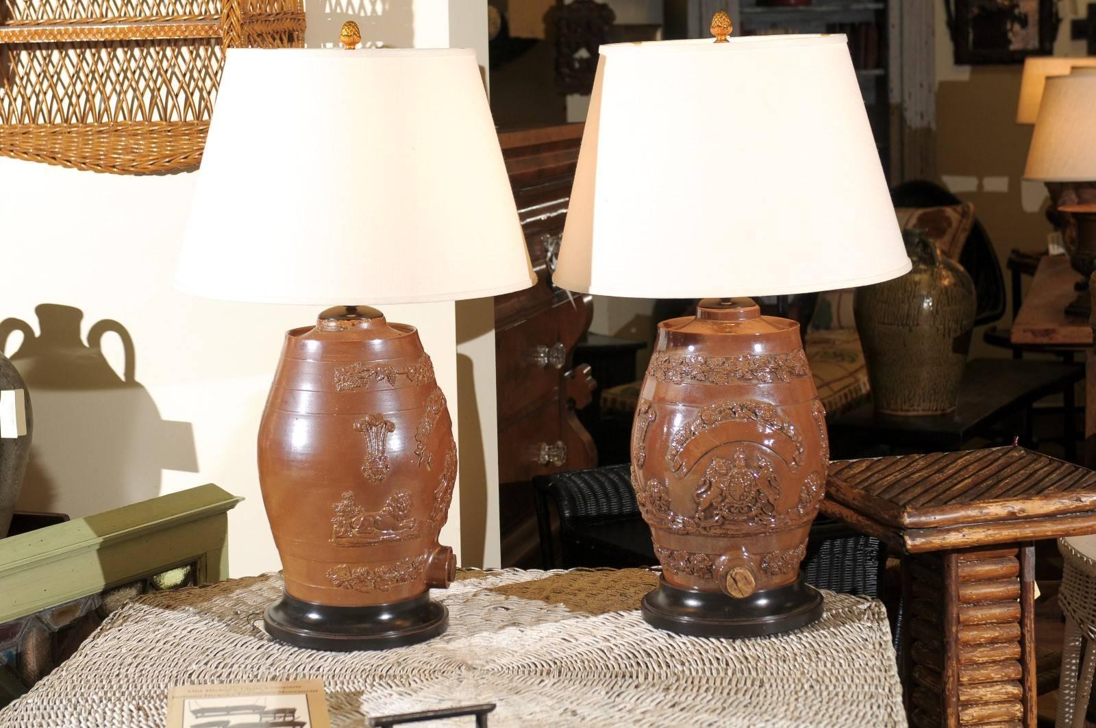 This pair of English salt glazed water filter lamps are a medium brown color. The main part of the lamps have the raised words "Dieuet Mondroit" which is the motto of the United Kingdom outside of Scotland, meaning "God is my