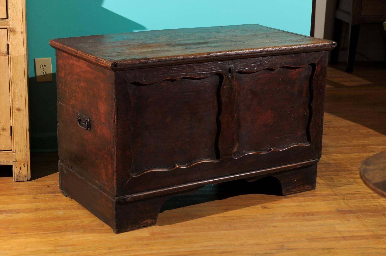 This English coffer has its original paint. The coffer is made of pine and is dovetailed down both sides. Old iron strap hinges run down the back of the chest.