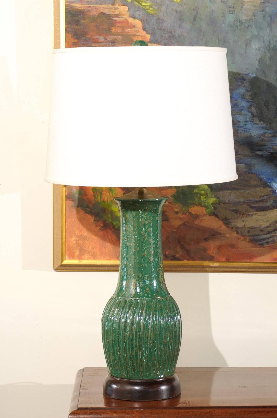 This unique hand-turned lamp is created by Charlie West, a noted North Georgia potter since 1986. It is mounted on a wooden base which is hand-turned on a wood lathe. Each of his lamps is an original.