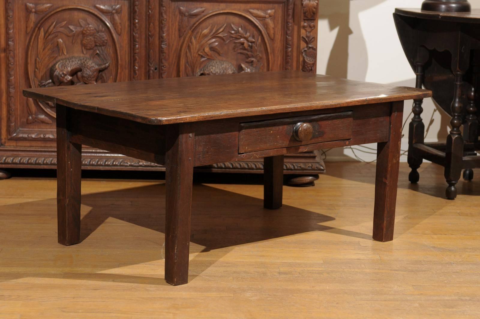 This is a French Pine coffee table with one single drawer. It was reduced in height from a French side table.