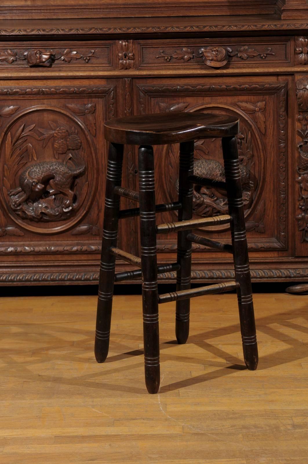 This is a lovely kitchen or bar stool. The rich finish on this stool will add class to any bar area. The British call it a bum stool. The shape of the seat is like a saddle and is extremely comfortable.
