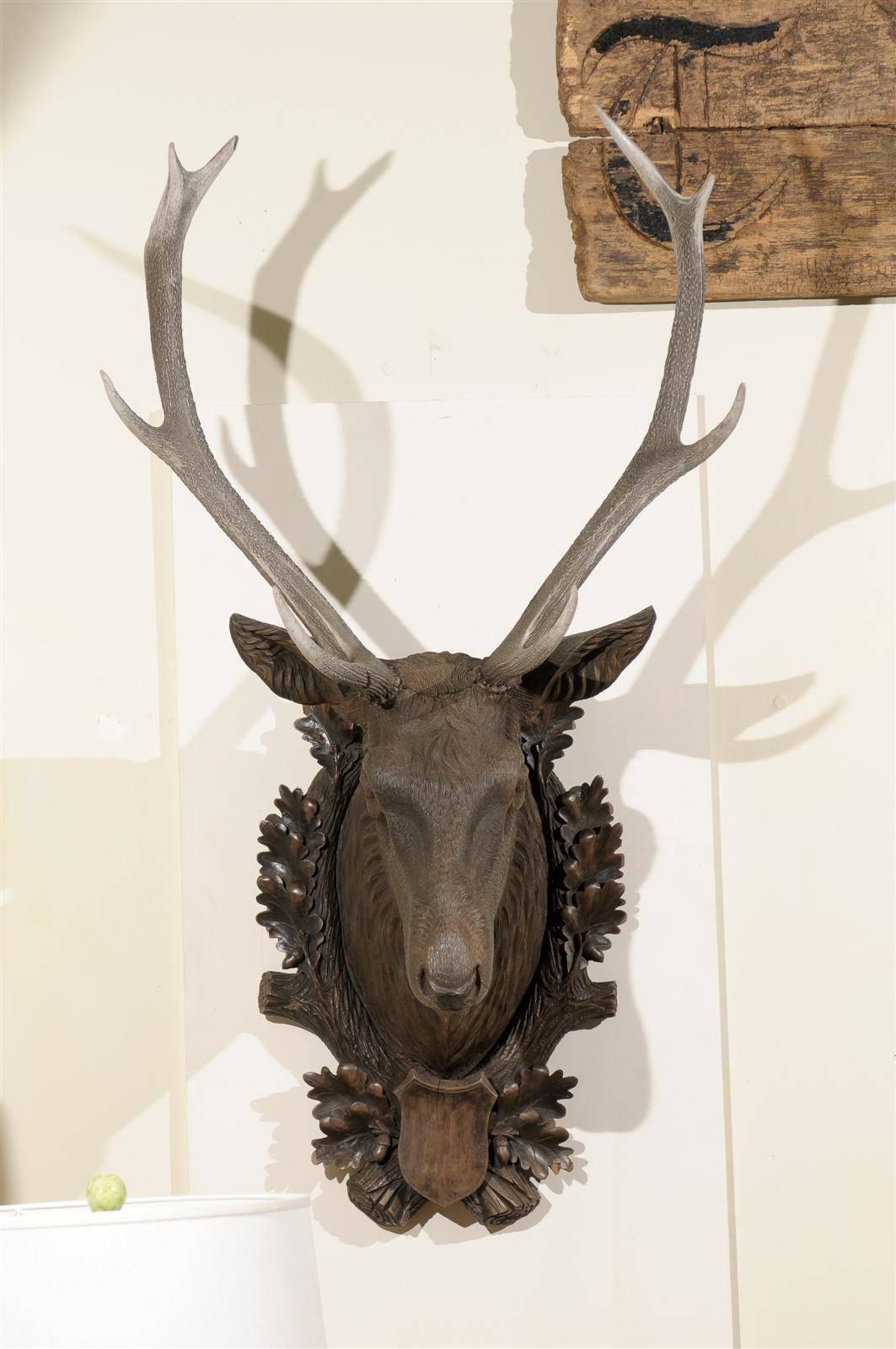 In the 1800s in Switzerland carvers were interested in carving things related to the outdoors such as hunting, skiing and wildlife. A stag head of this size is very rare and hard to come by. The oak wreath around the neck of the stag represents a