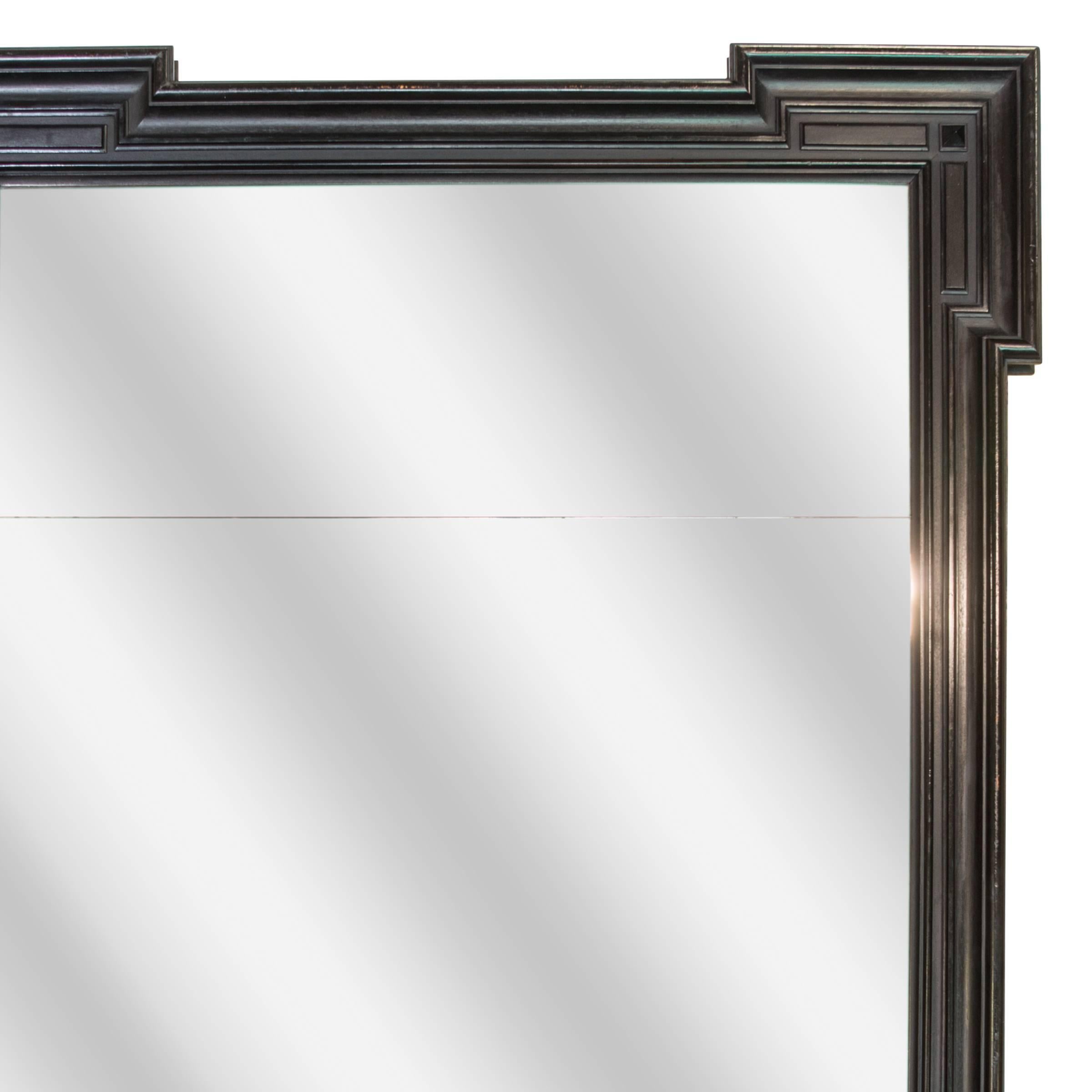 Newly ebonized mahogany mirror; distressed glass in two parts.

France, circa 1860.