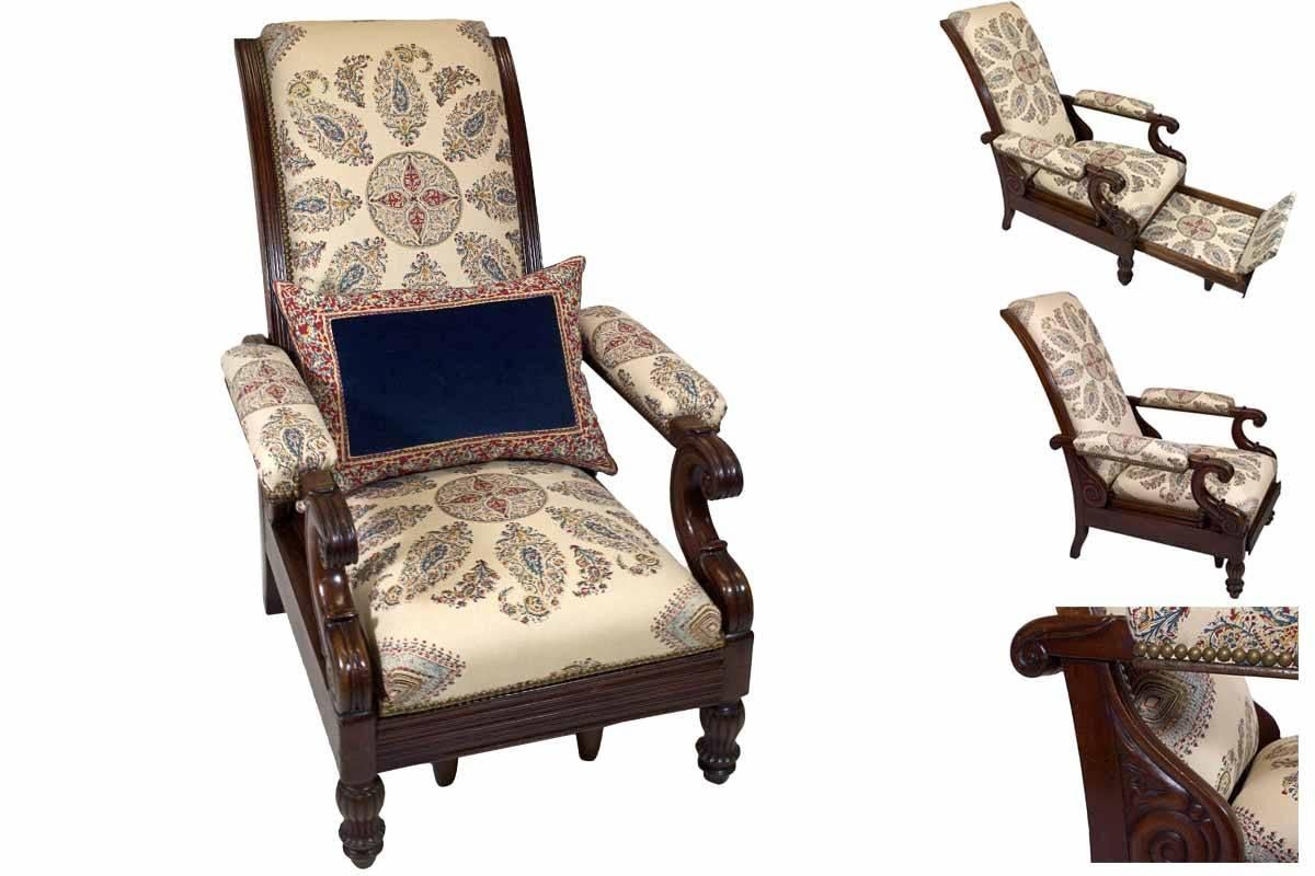 A late Empire mahogany armchair featuring hand-printed blue and red paisley linen upholstery with original pull-out foot rest mechanism.

Measurement extended:
39