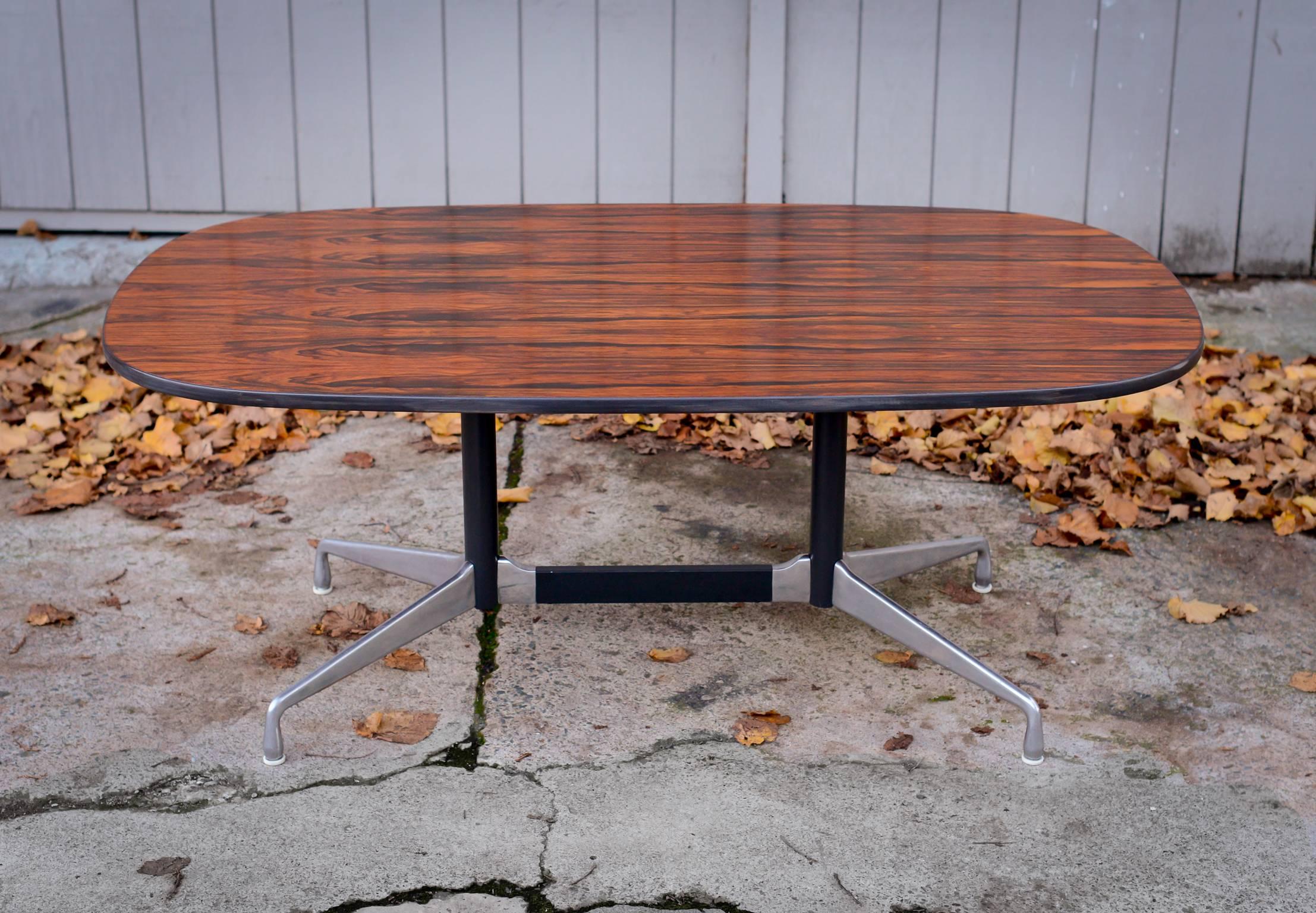 Eames segmented base aluminum group table for Herman Miller, 1964.
Dining/conference/writing table with Rosewood top and extruded,
aluminum base.
Eames segmented base/aluminum group table for Herman Miller 1964. 
Out of production lozenge