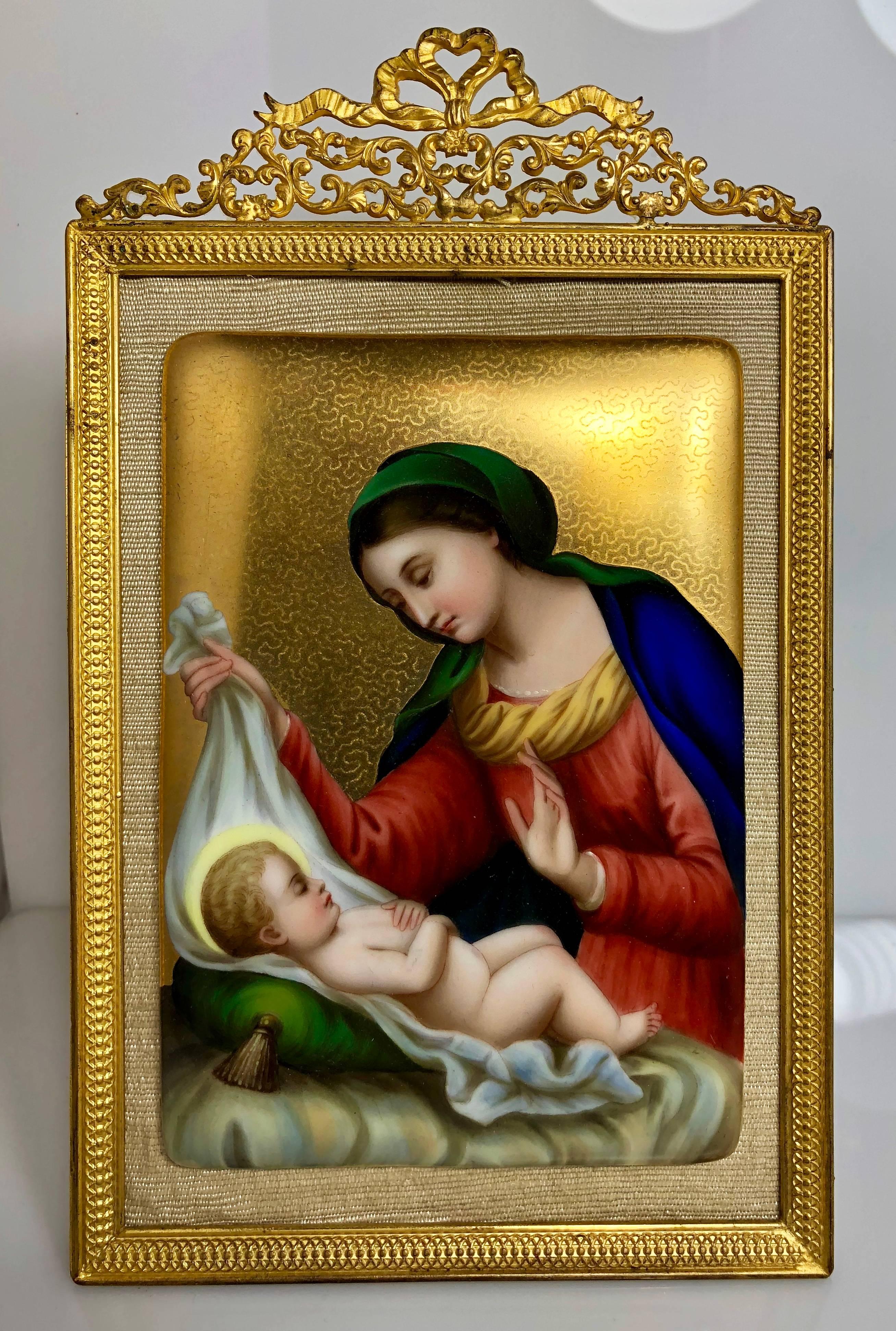 Antique French hand-painted Madonna and child on porcelain, mounted on a bronze doré frame.