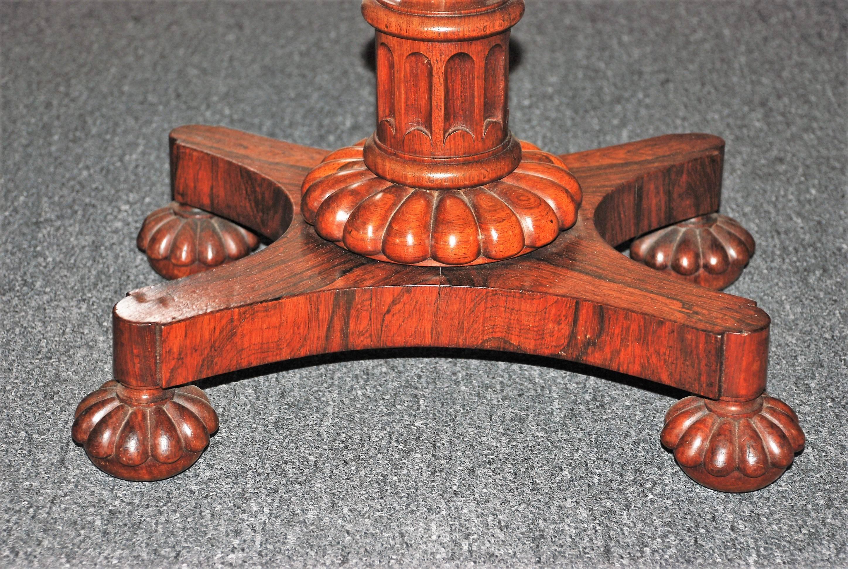 Antique Georgian hand-carved rosewood tea poy with bun feet and castors.