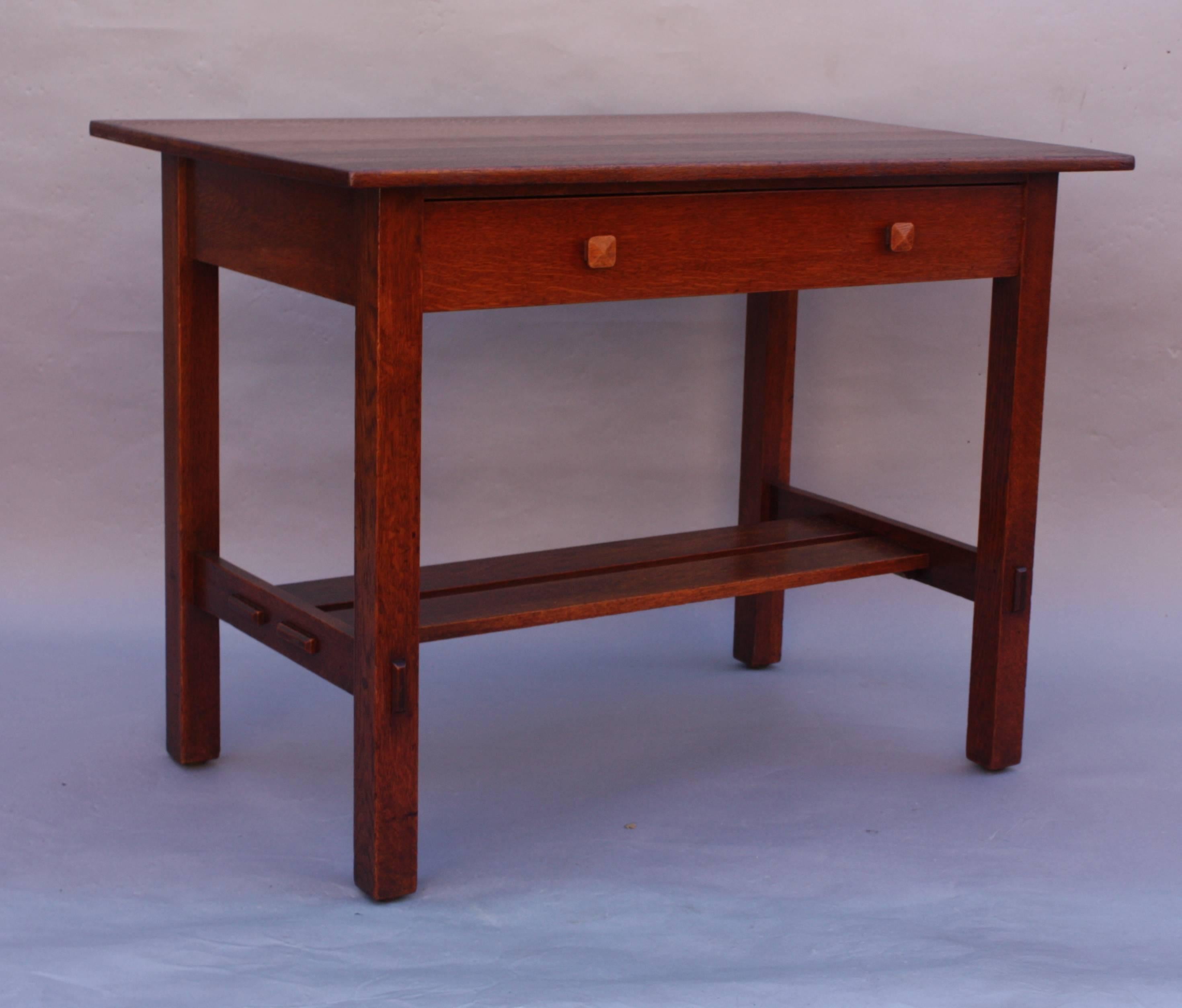 Arts and crafts desk with single drawer, circa 1910. Double stretchers. Pinned construction. Quarter sawn oak. Restored finish.