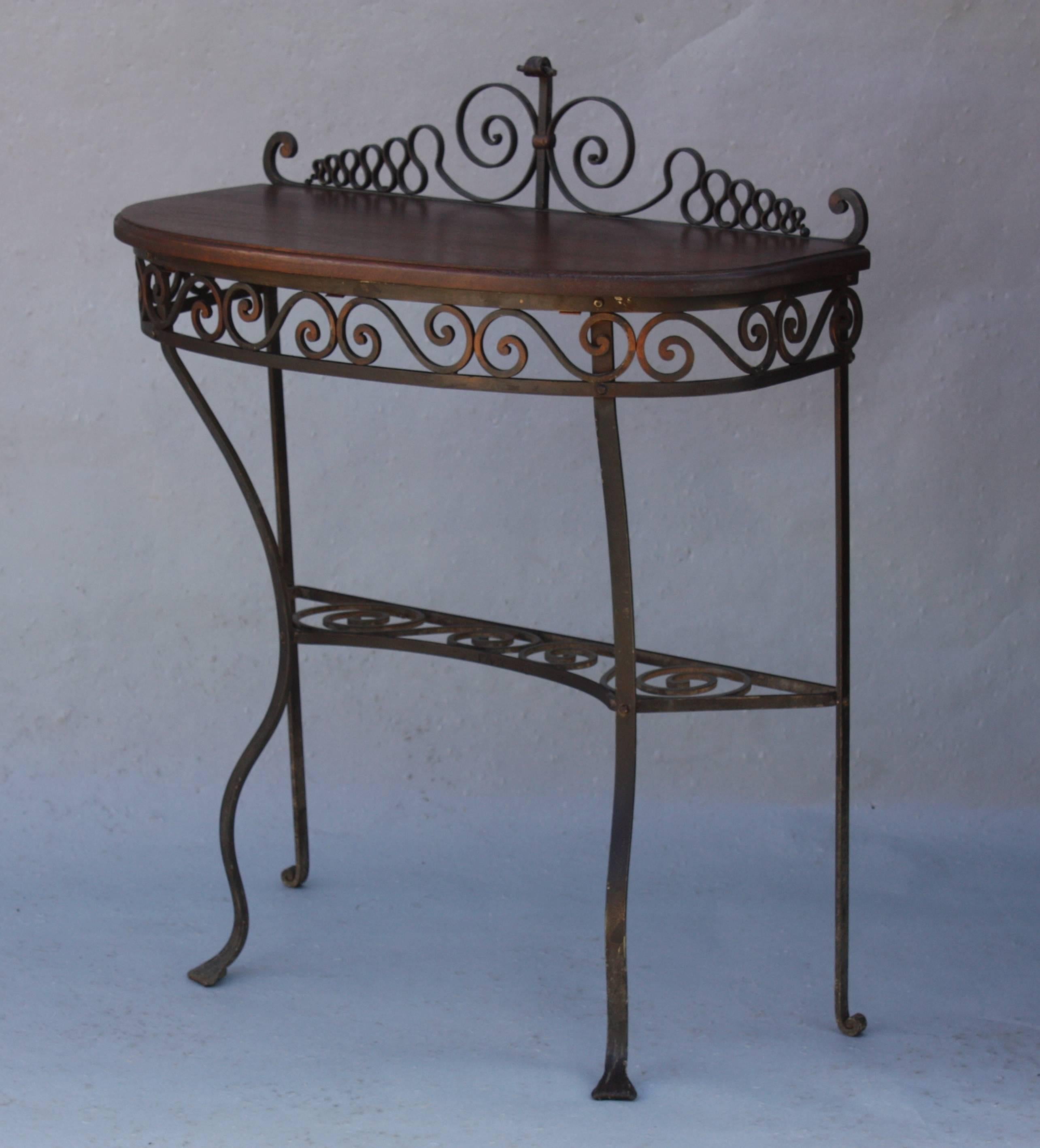 Demilune table with beautiful iron work, circa 1920s. Measures: 36