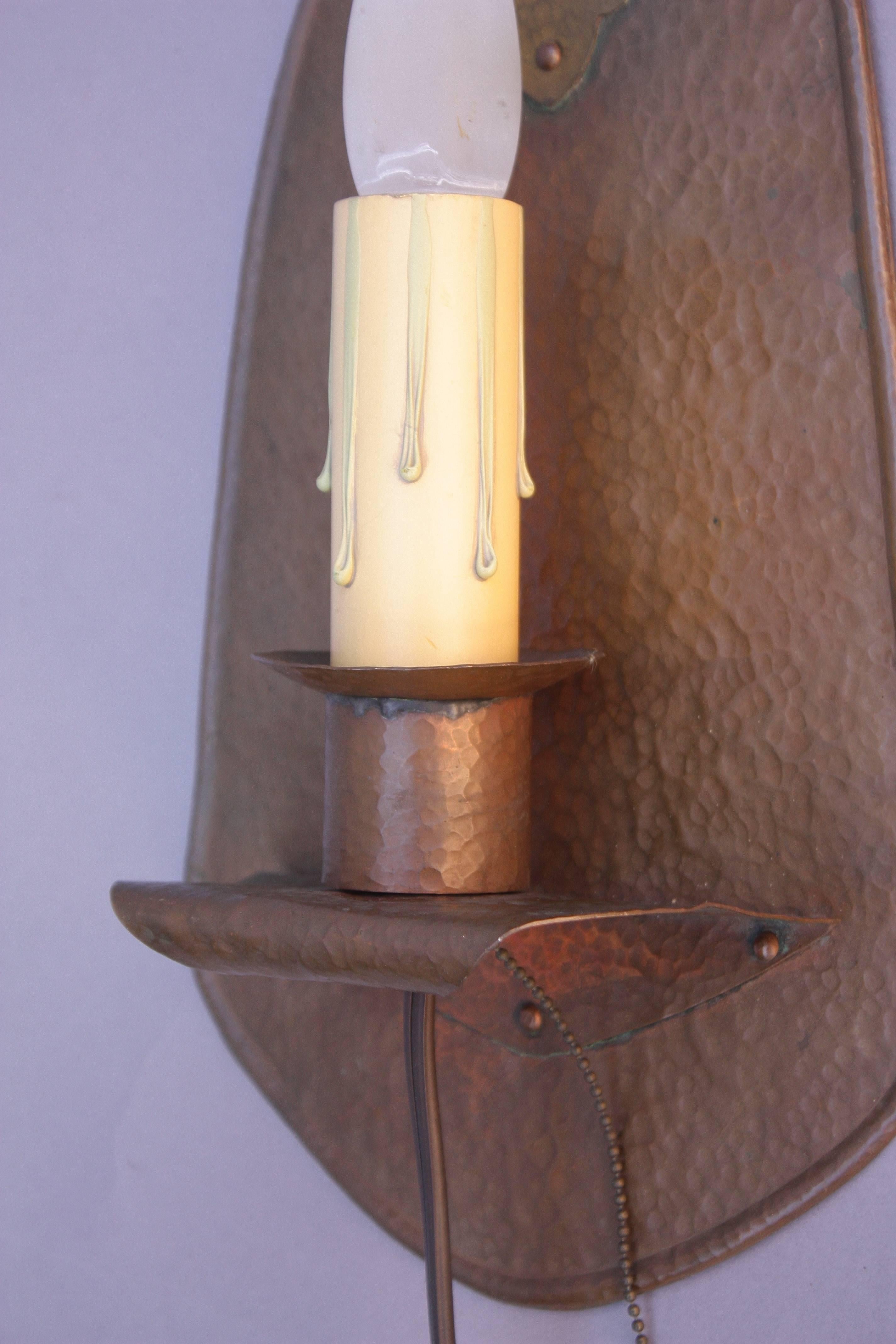 Single light hammered copper sconce from the turn of the century.