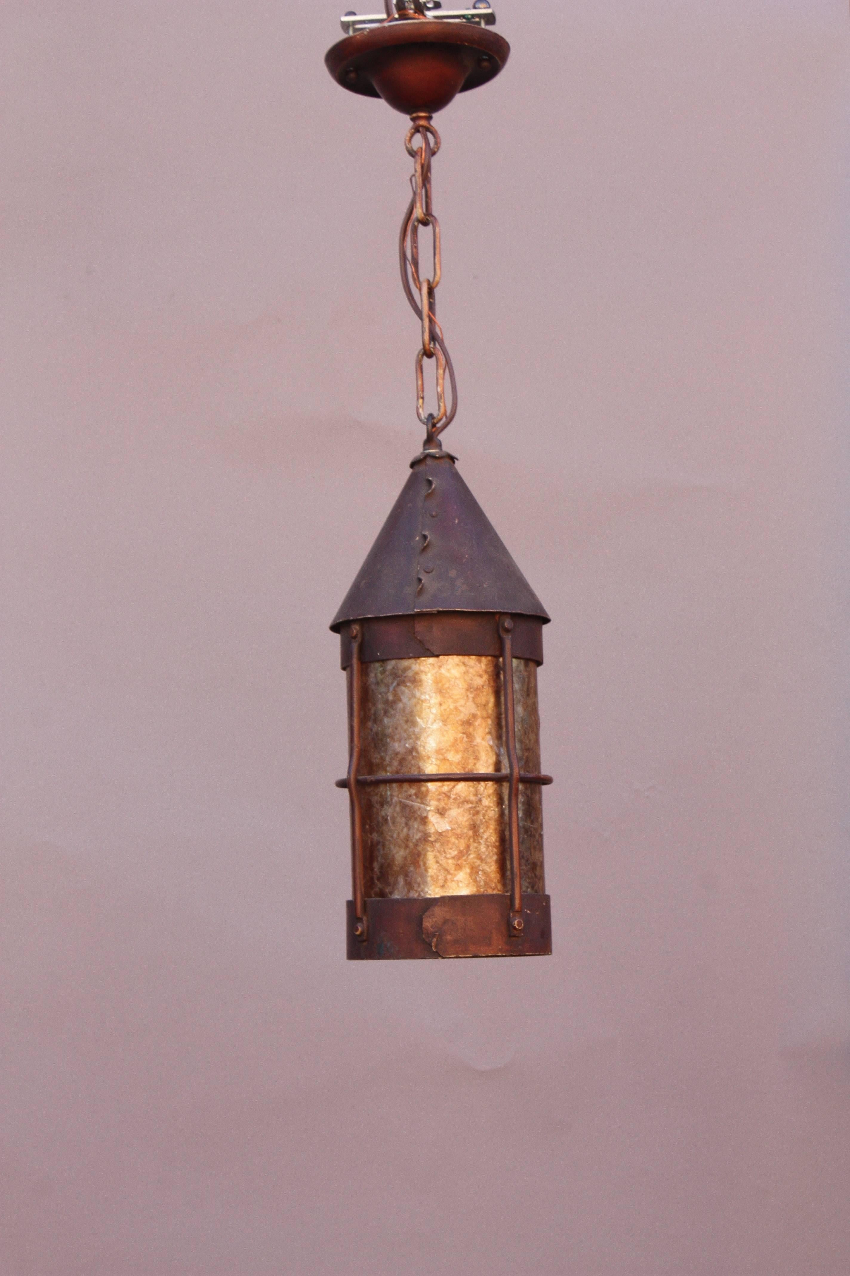Arts & Crafts period iron pendant light with mica, circa 1910.