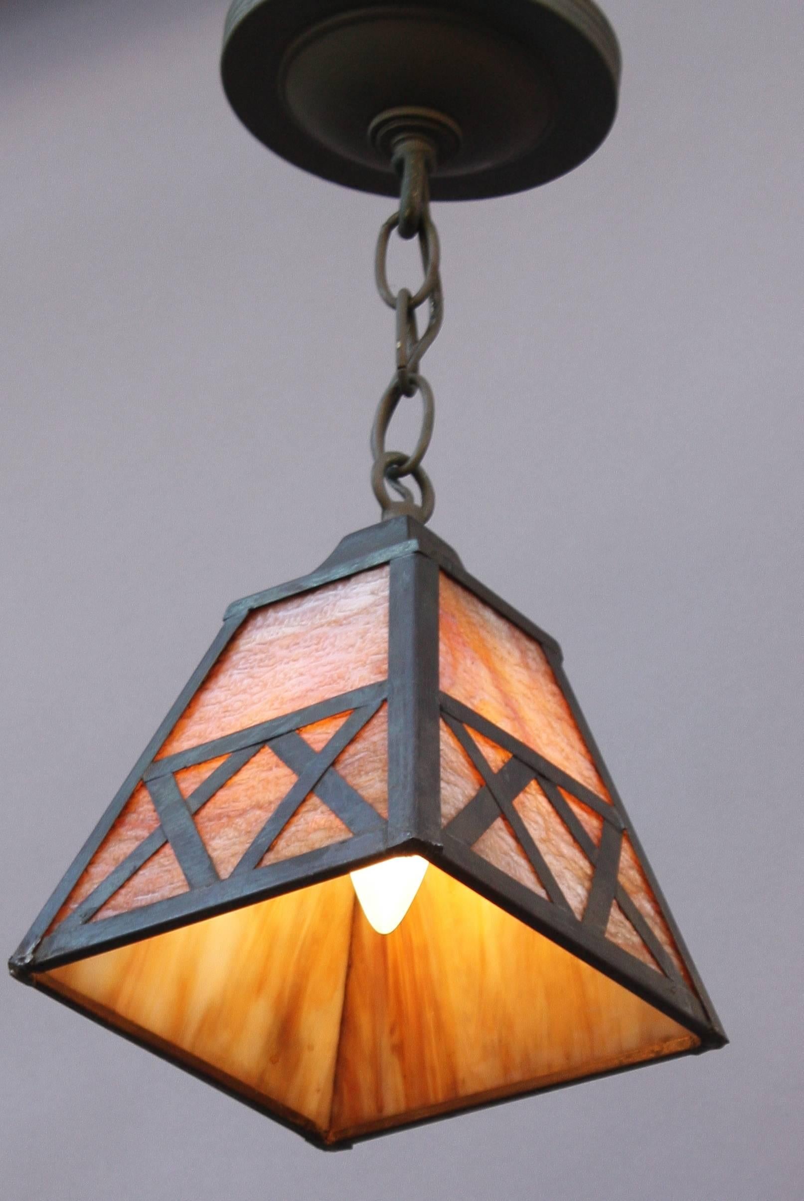 One of two arts and crafts pendant lights. Priced and sold individually, circa 1910 pendant with slag glass.