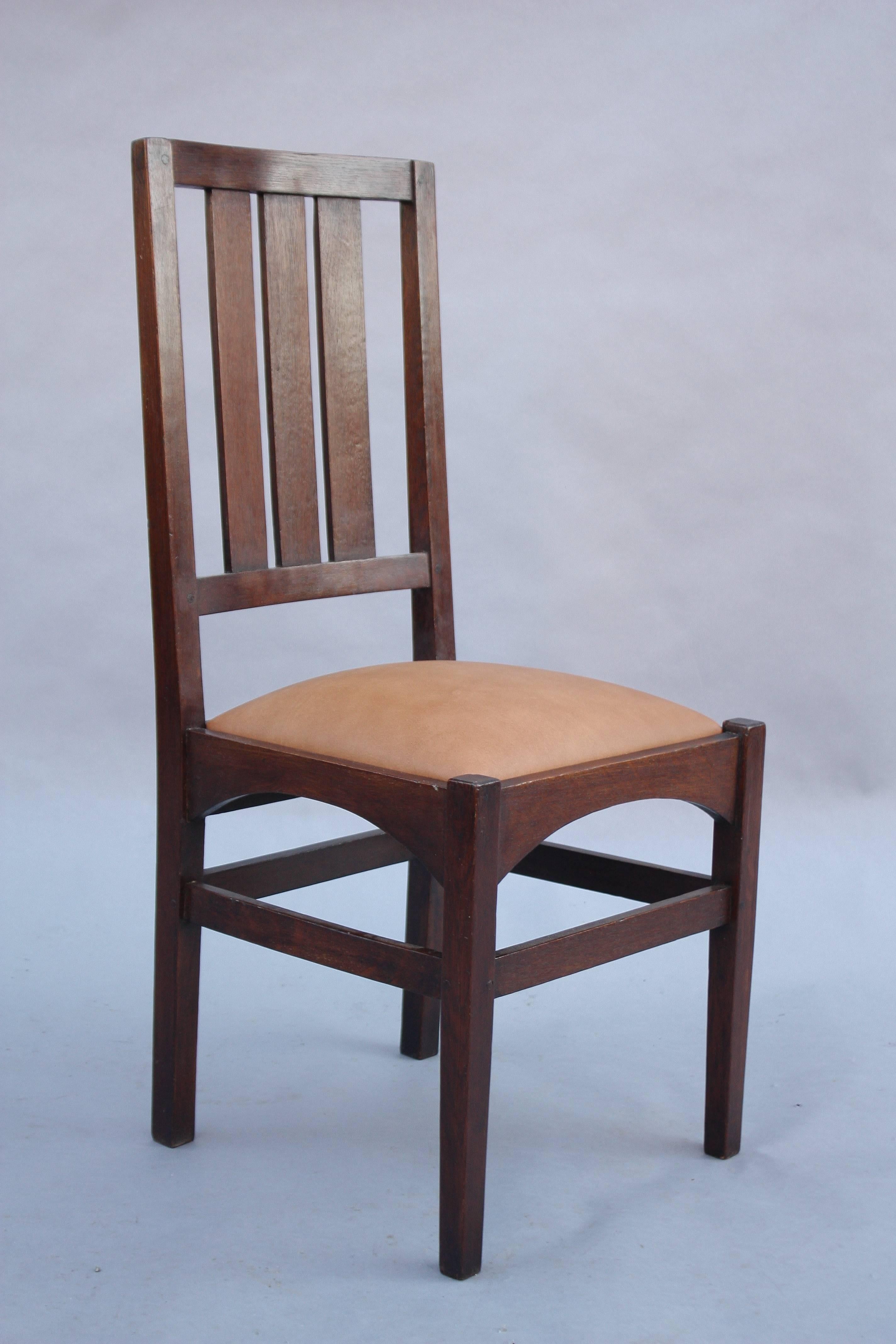 Arts & Crafts period oak side chair with new leather upholstery.