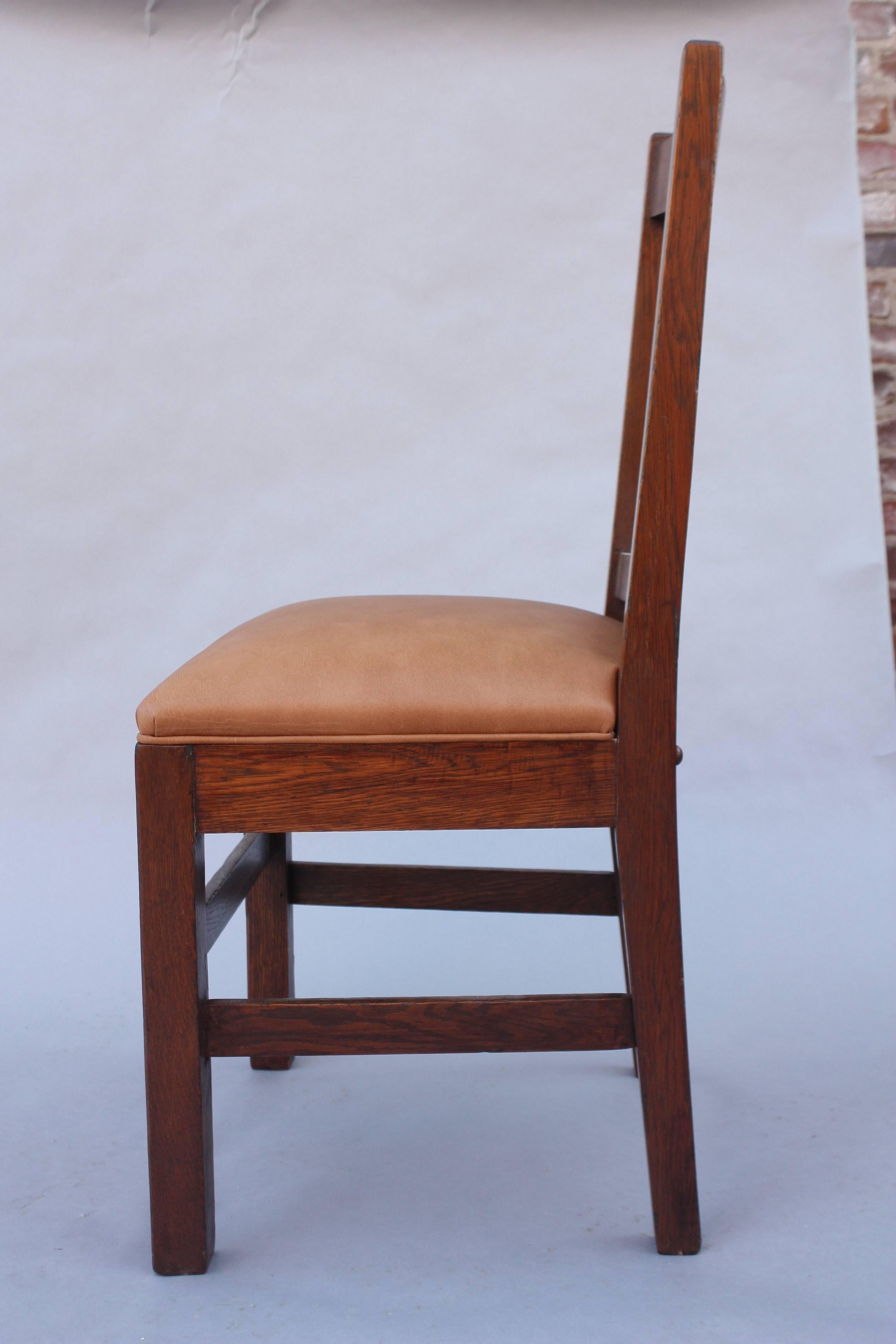 Craftsman period oak side chair with new leather upholstery.