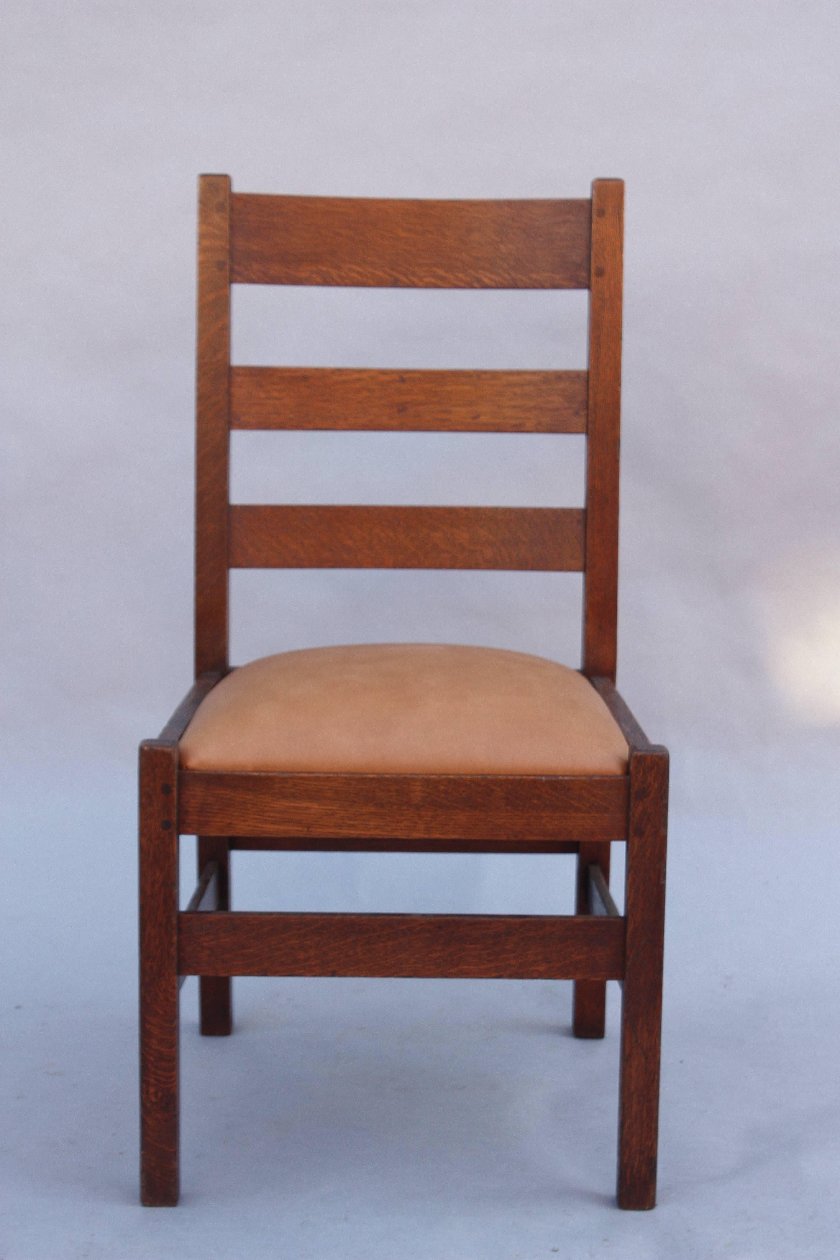 Arts & Crafts period oak side chair with new leather upholstery.