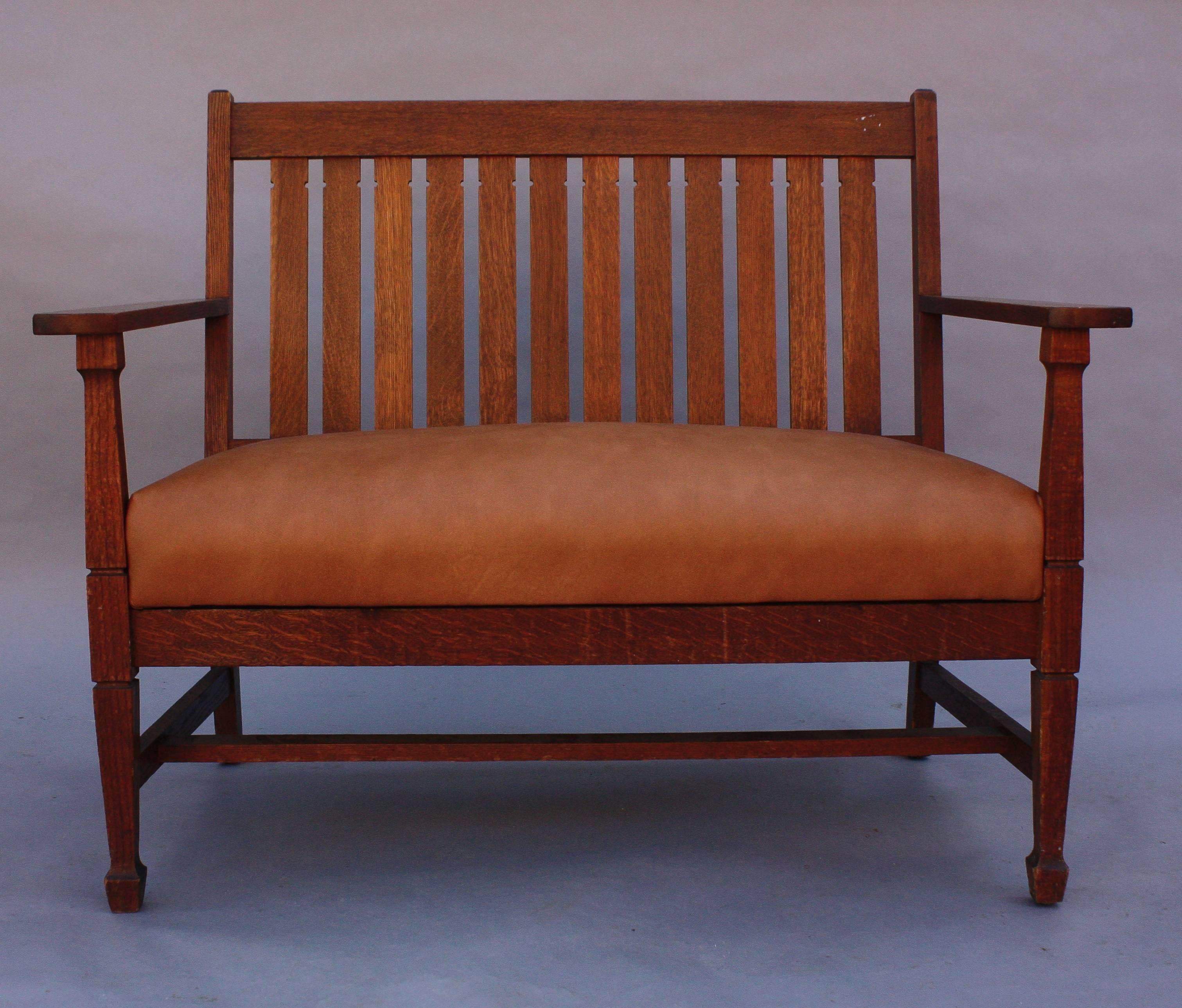 Oak settle with new leather upholstery, circa 1910.
