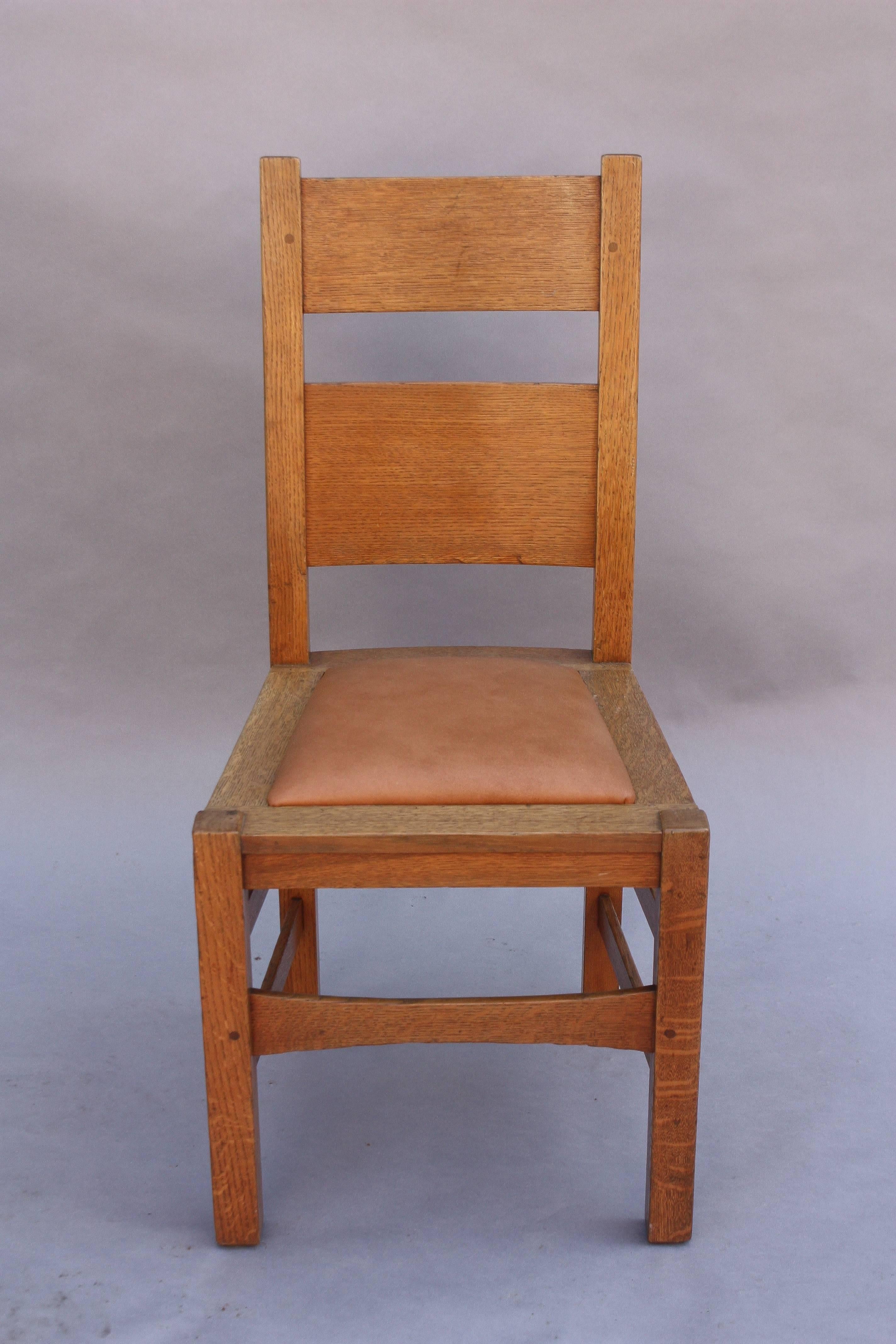1910, craftsman era side chairs with light finish and new leather upholstery. Priced and sold individually.