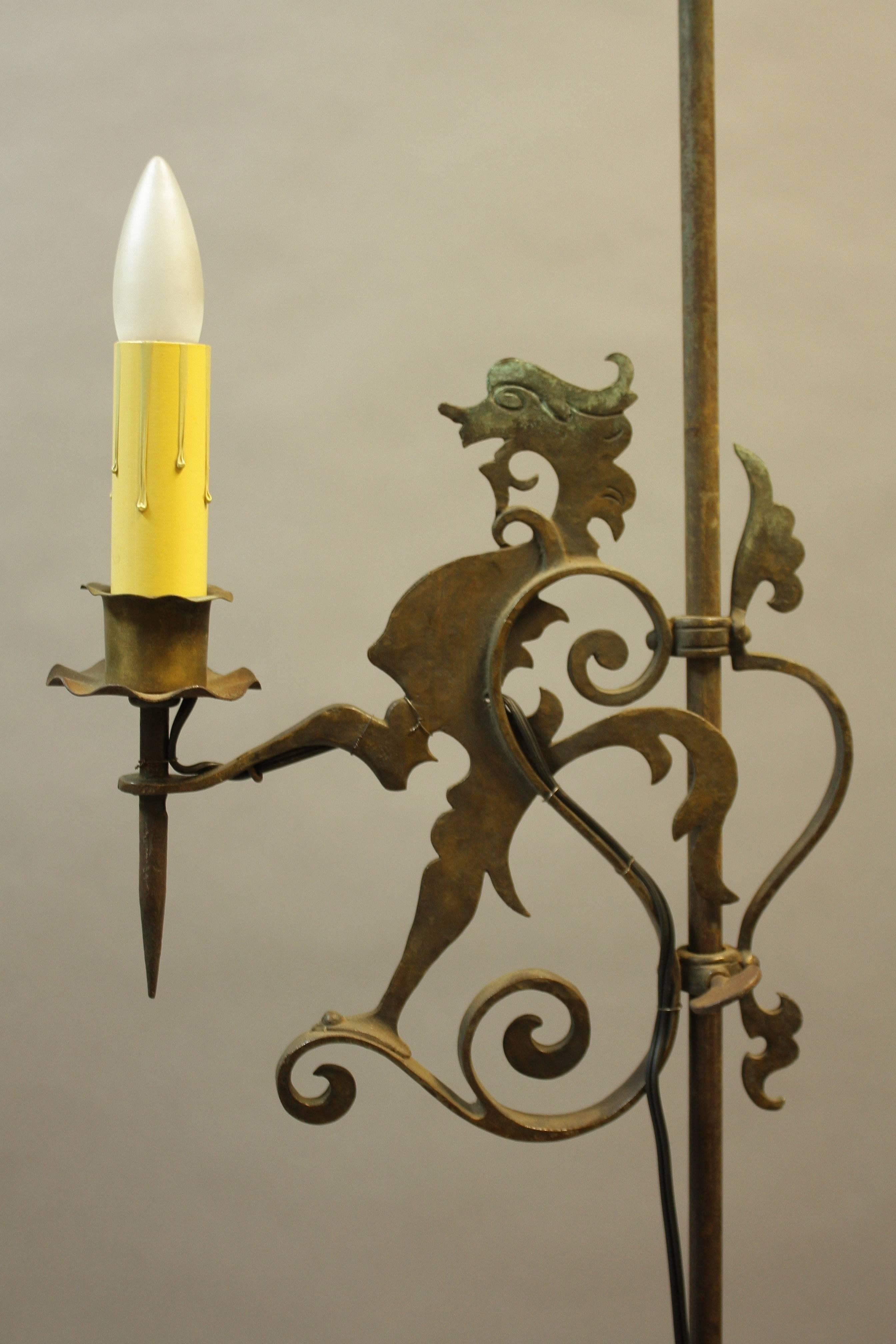 Standing lamp with mythical creature, circa 1920s. Standing lamp adjusts up and down. Measures: 50.13