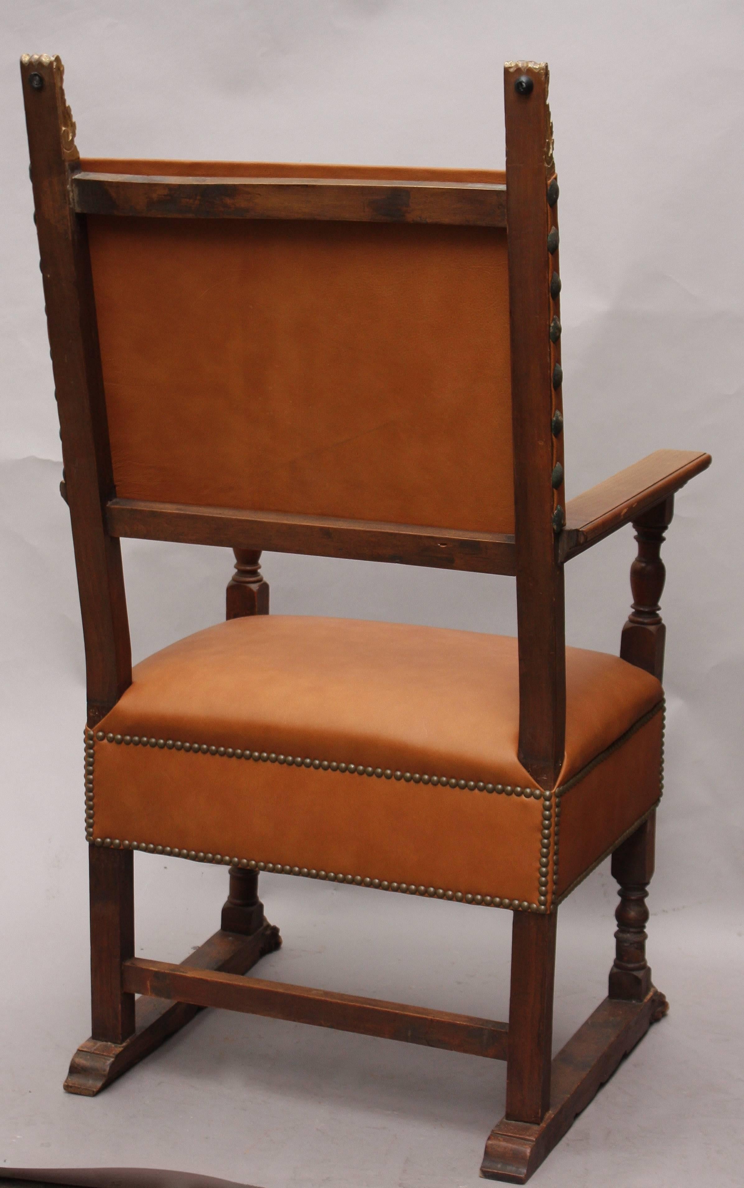 Beautifully carved Spanish Revival chair with new leather upholstery, circa 1920s. Measures: 49.5