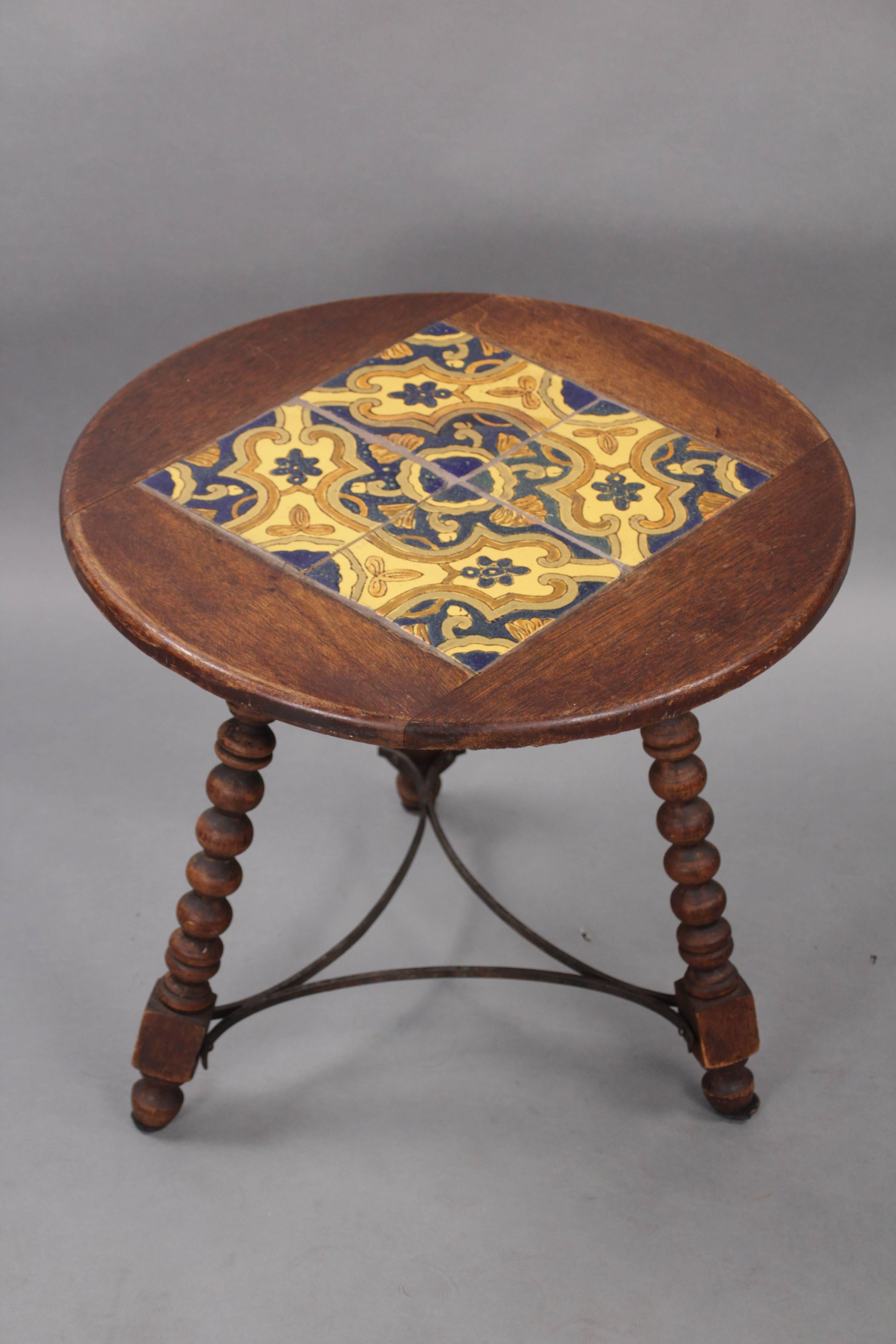 Wonderful round tile table with turned legs and iron stretchers, circa 1920s.