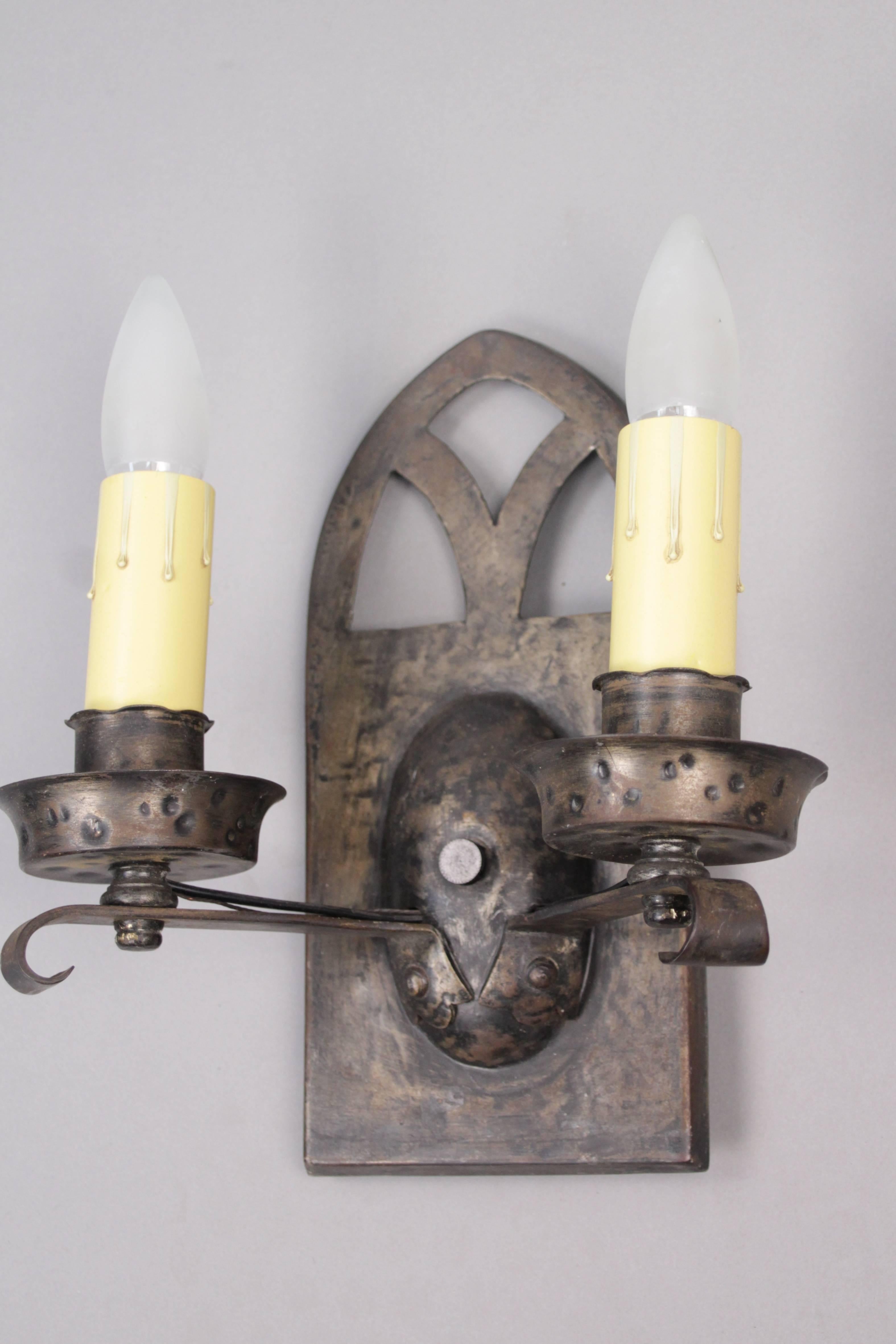 Priced and sold individually. One of four double light sconces with hammered finish, circa 1920s.