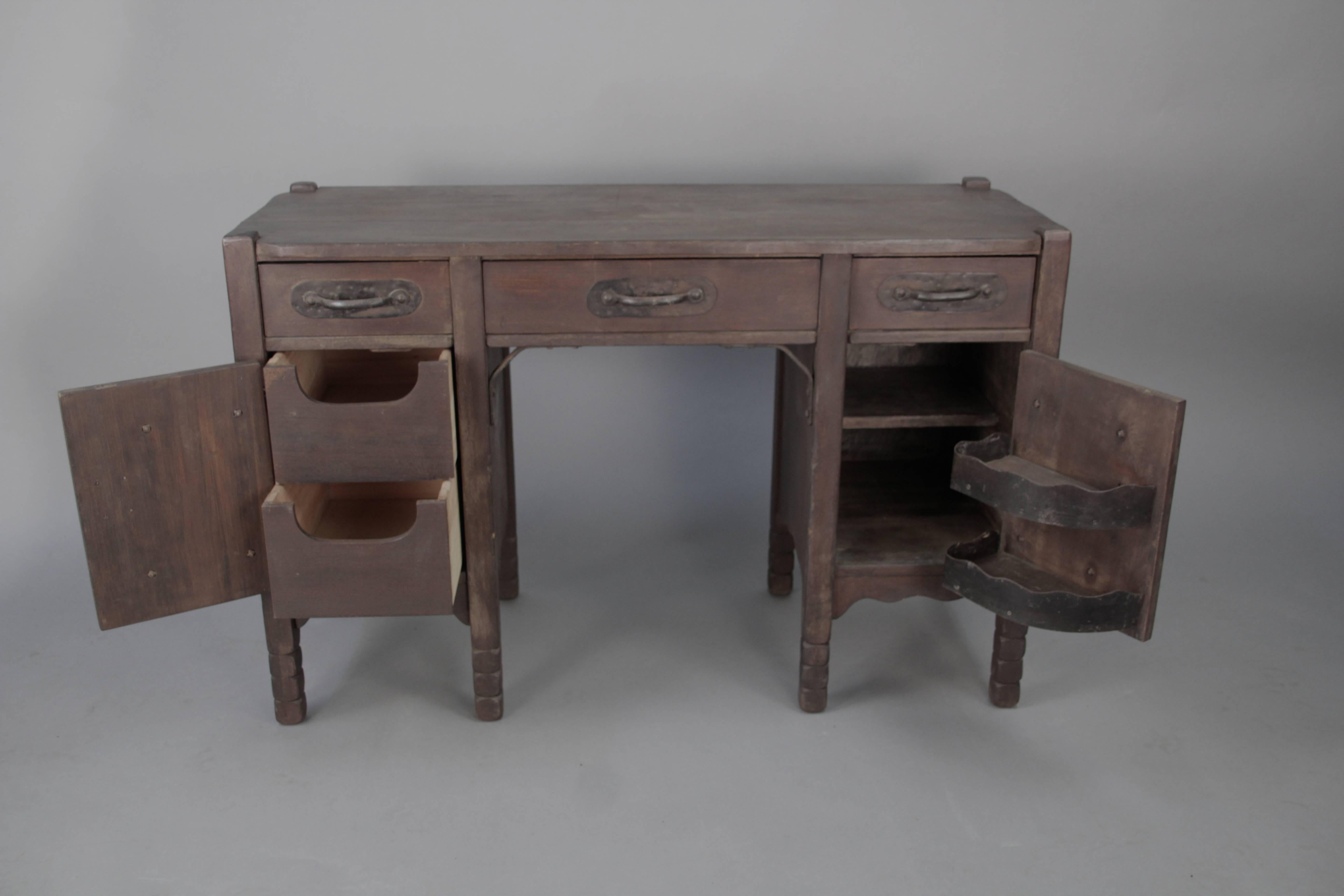 Early Monterey 1930s desk with original finish. Original metal inserts inside right cabinet. Signed.