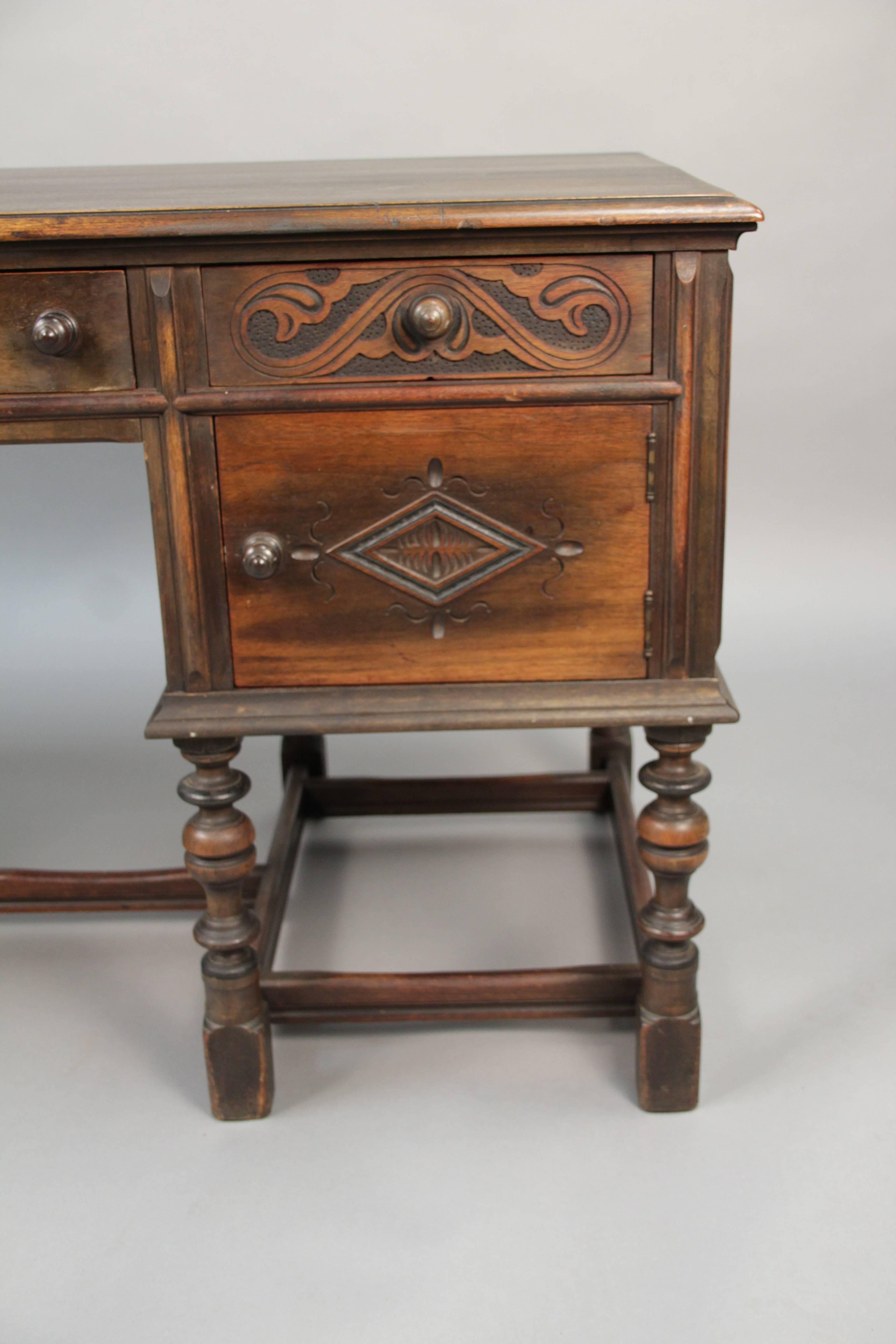 Wonderfully carved wood desk with turned legs, circa 1920s.