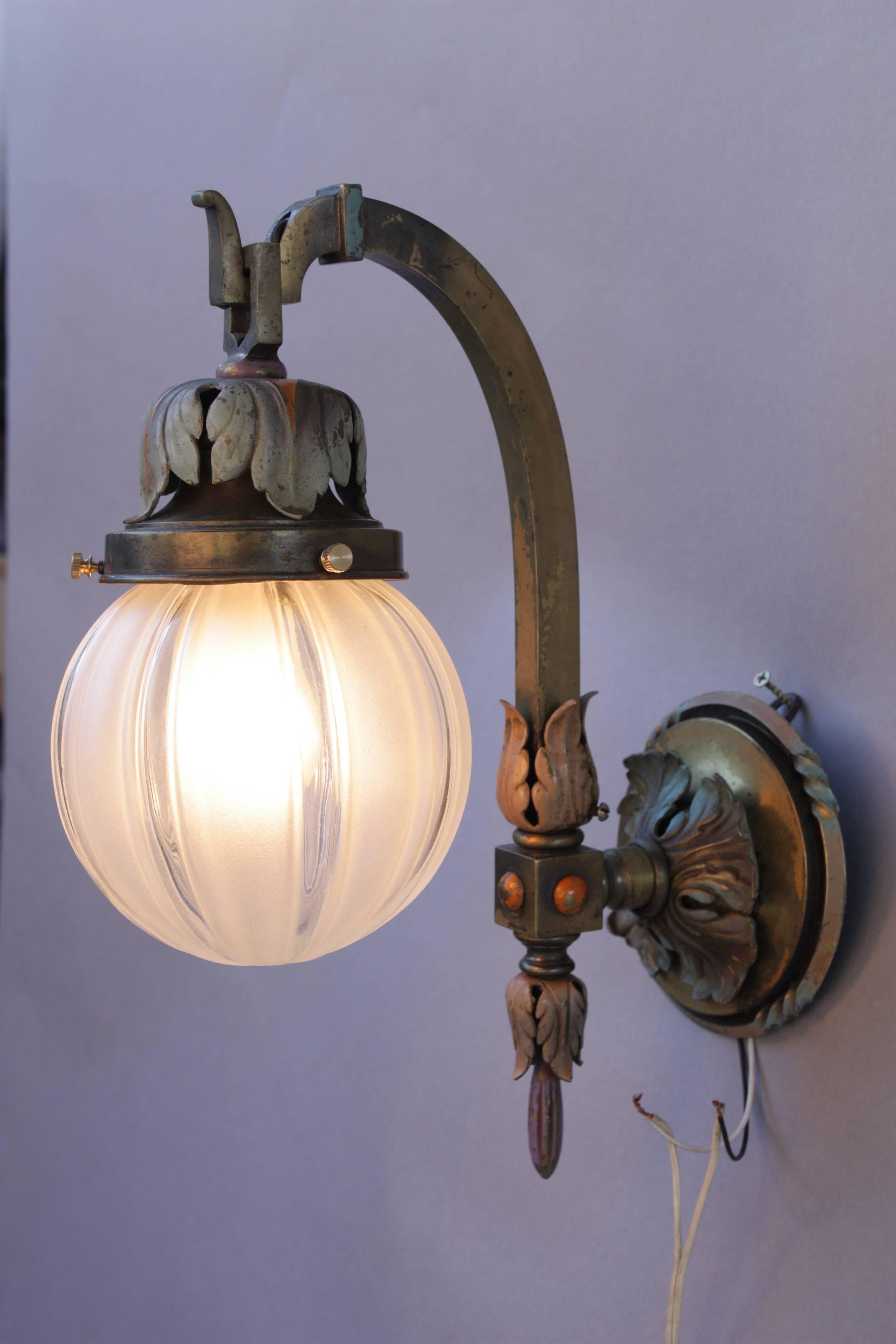 circa 1920s pair of downlight sconces with original 1920s glass and original finish. 15.75