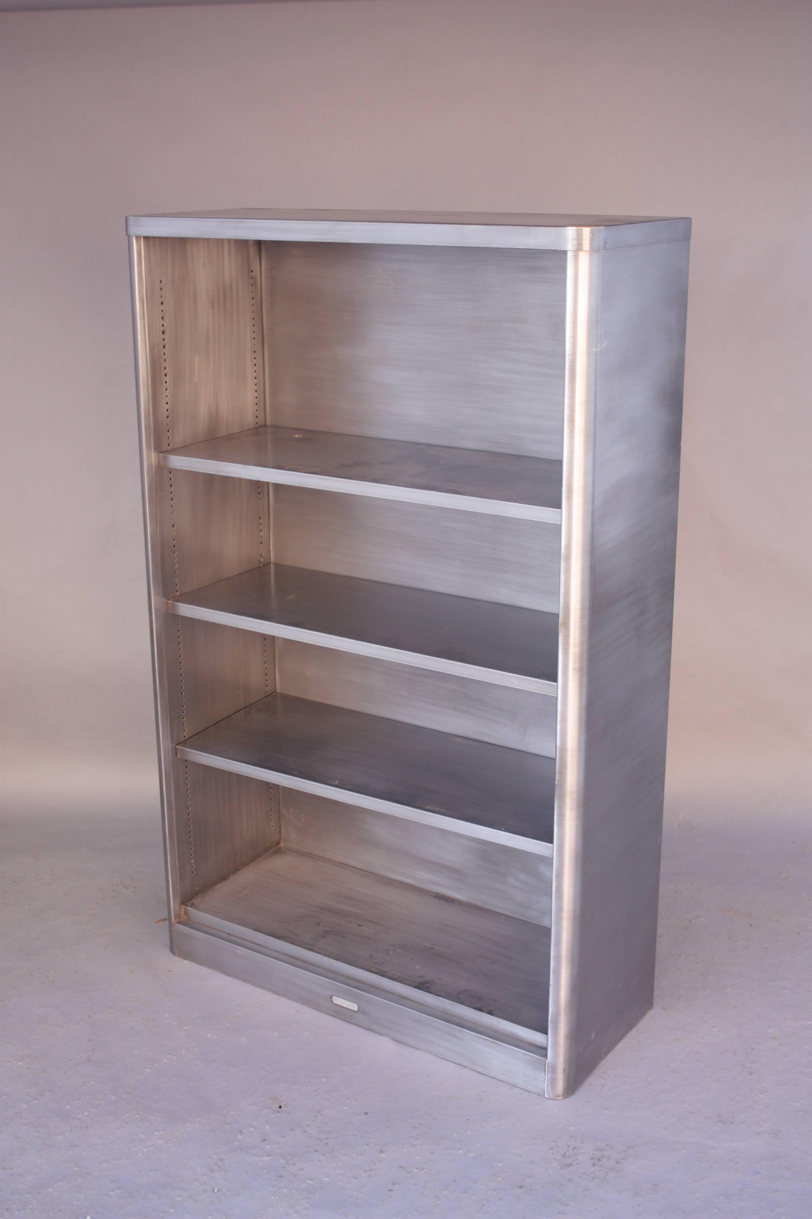 Great metal bookcase from the Industrial Period of the early 20th century. We have two available.