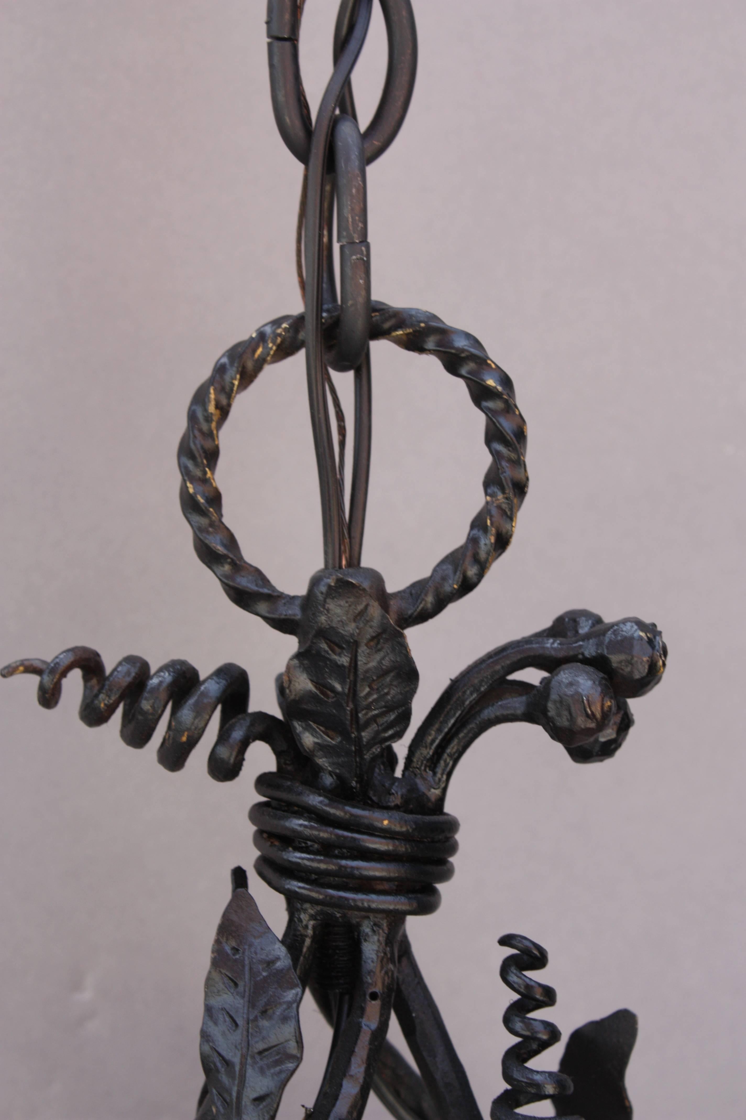 Unusually narrow and tall wrought iron chandelier with intricate vine-like design. Very nicely crafted with nice attention to detail.

Measures: 30
