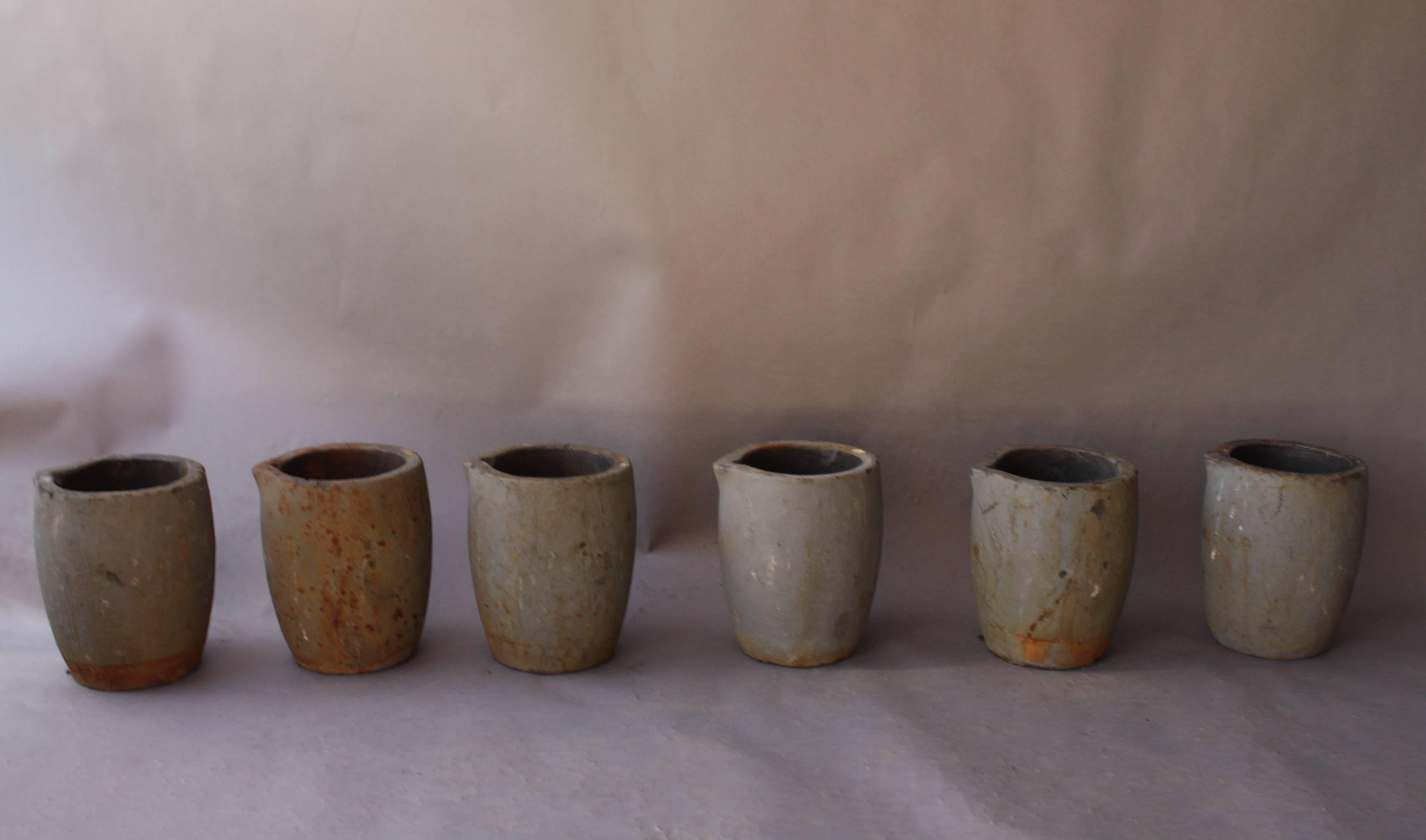 Priced for the collection of six. Industrial set of six Crucibles. These container were used for pouring melted metal. Measures: 14