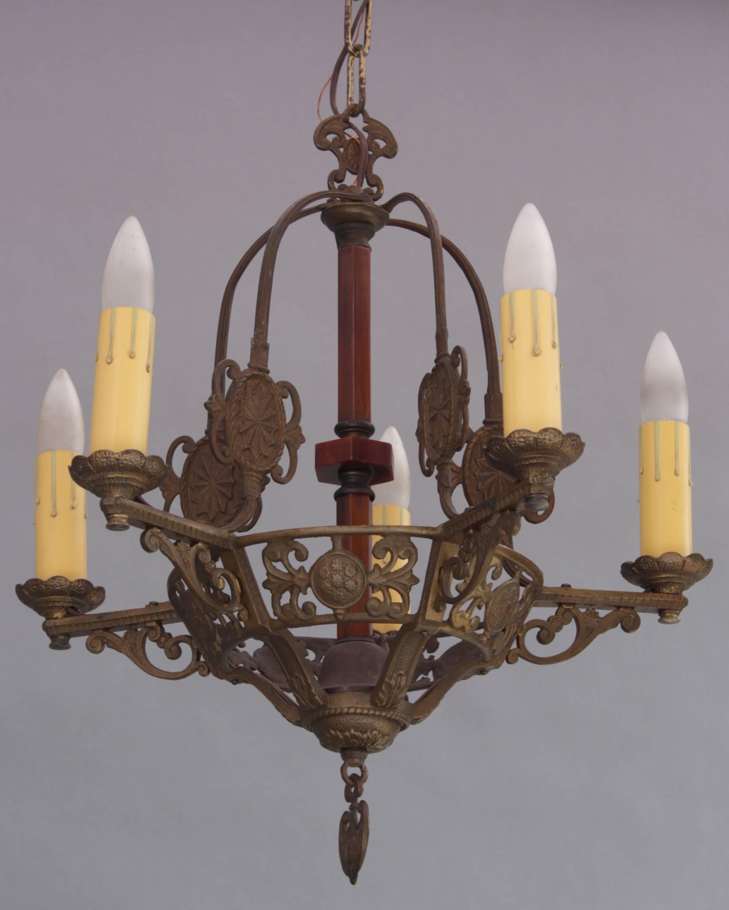 Intricately cast chandelier with richly colored bakelite column accent.
 