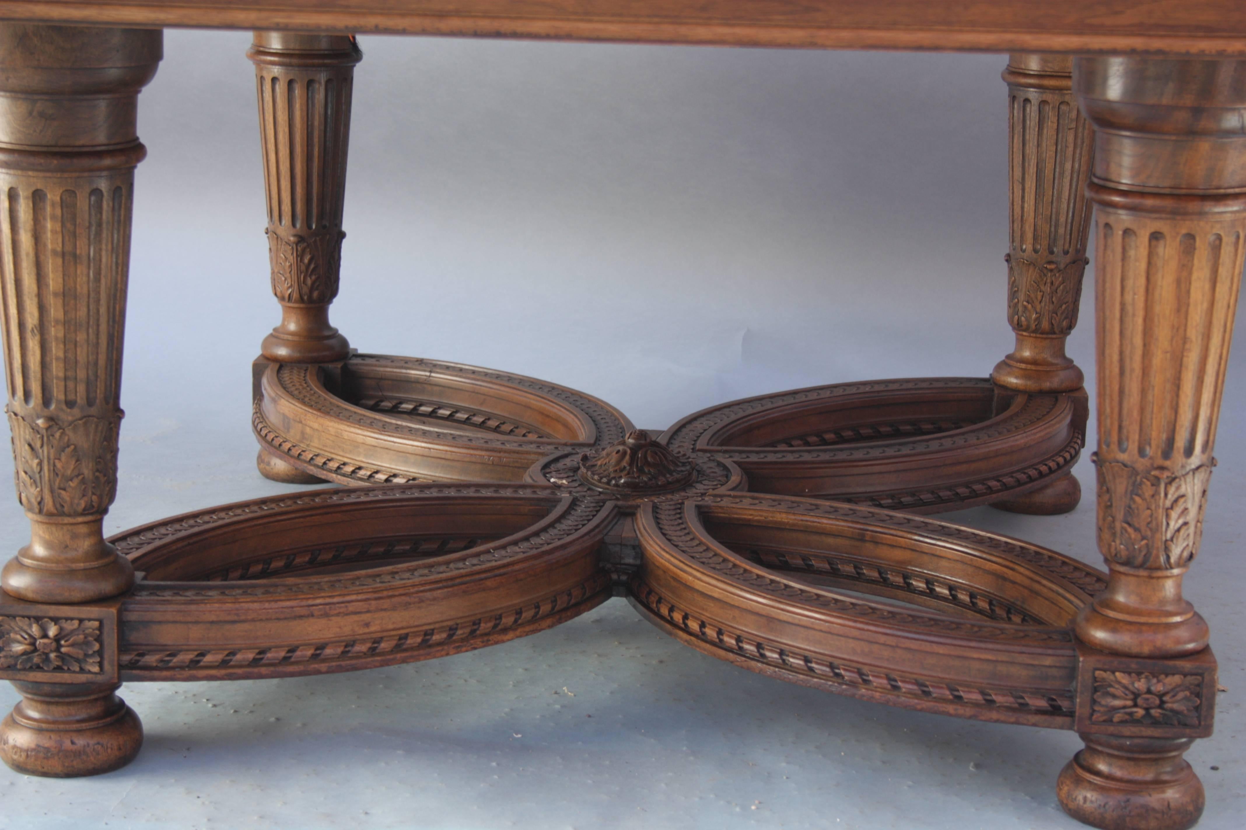 Turn of the century center table with intricate carving. Acanthus and ribbon motif. Carved walnut.