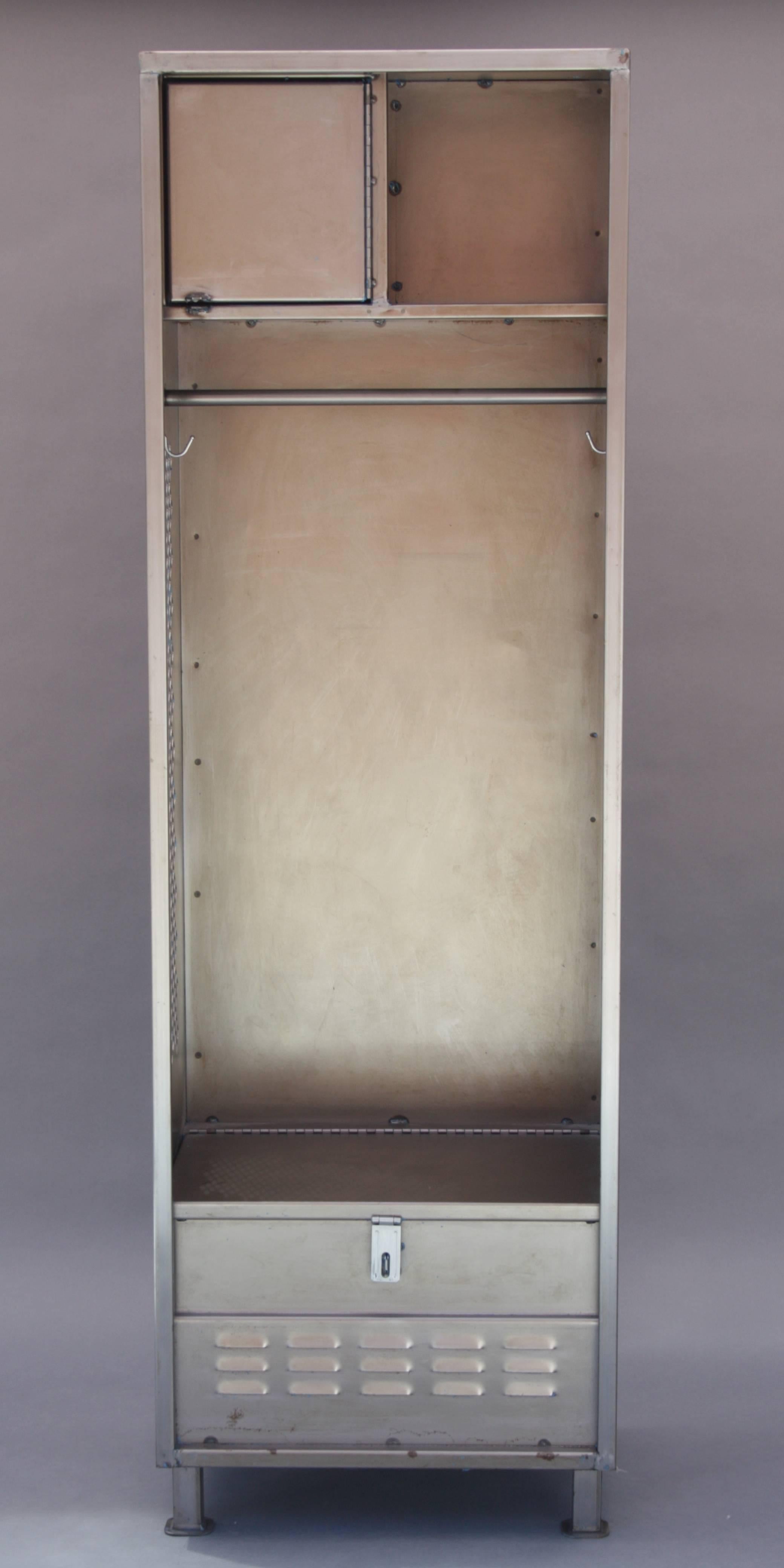 Mid-20th century Industrial metal locker with ample storage and hanging rack. Measures: 76.5