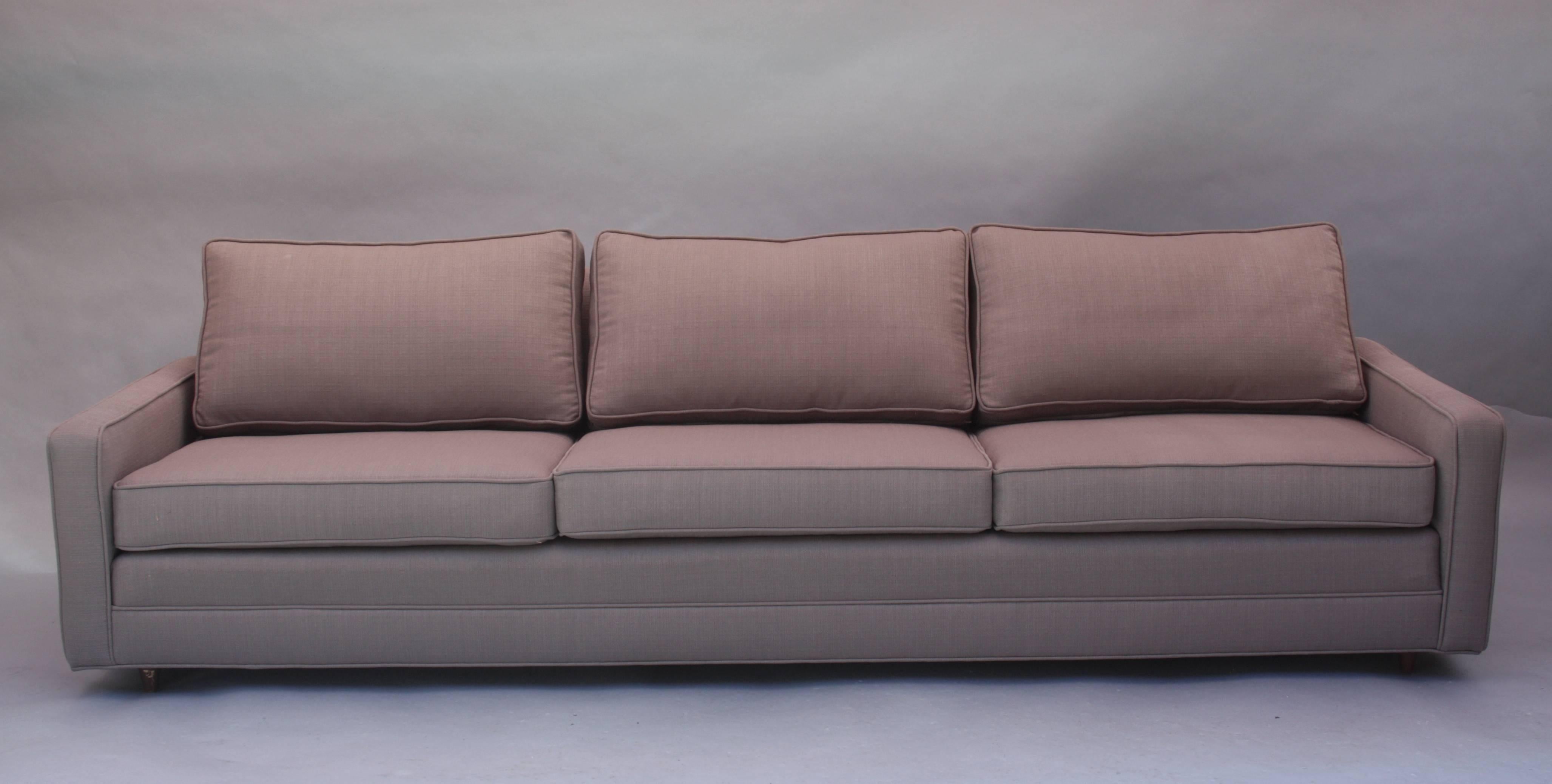 Mid-Century Modern sofa with new beige upholstery. We also have a coordinating armchair, sold separately.