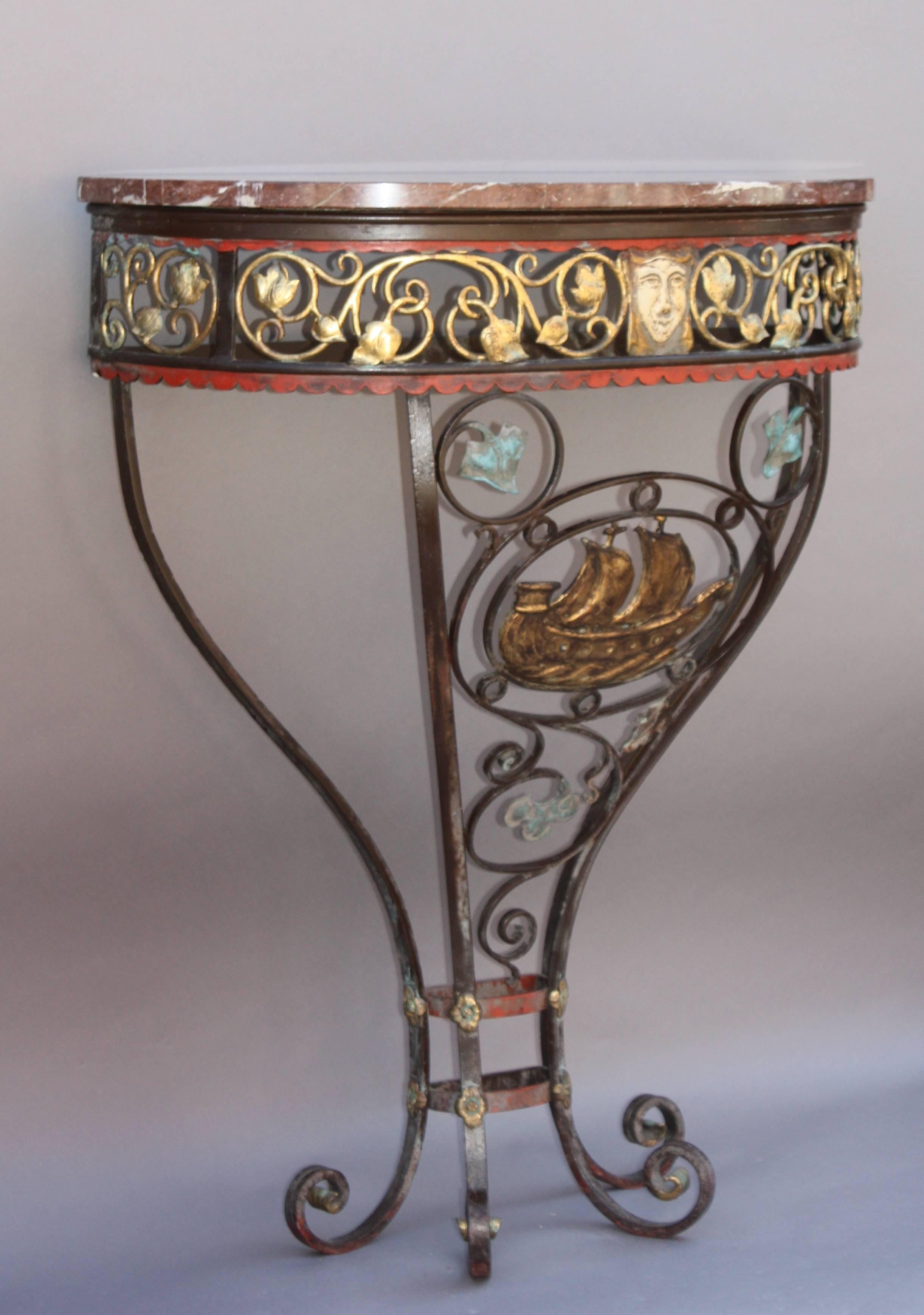 Priced and sold individually, circa 1920s console with marble ton and galleon motif. Polychrome wrought iron and bronze construction with marble top.