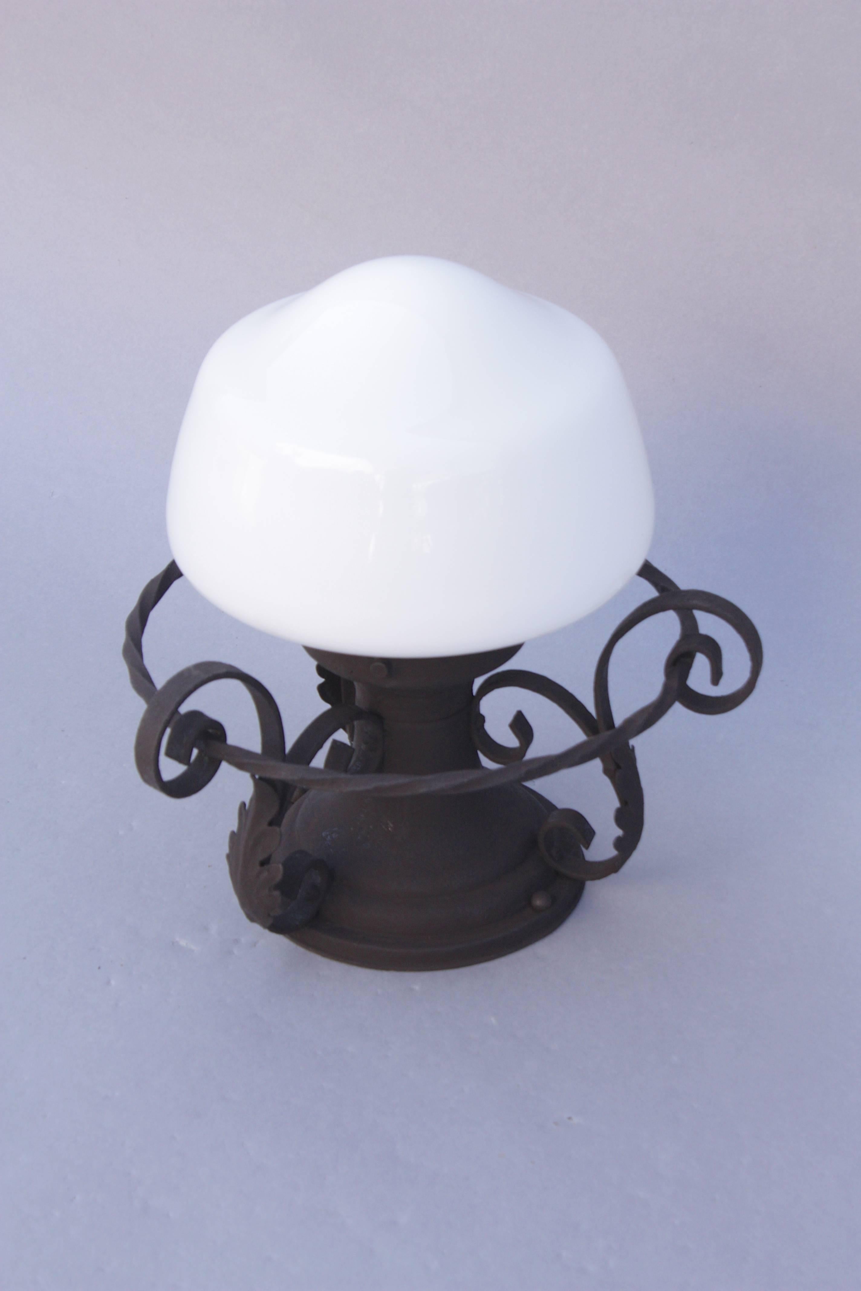 Spanish Revival ceiling mount fixture with acanthus leaf motif and milk glass globe.