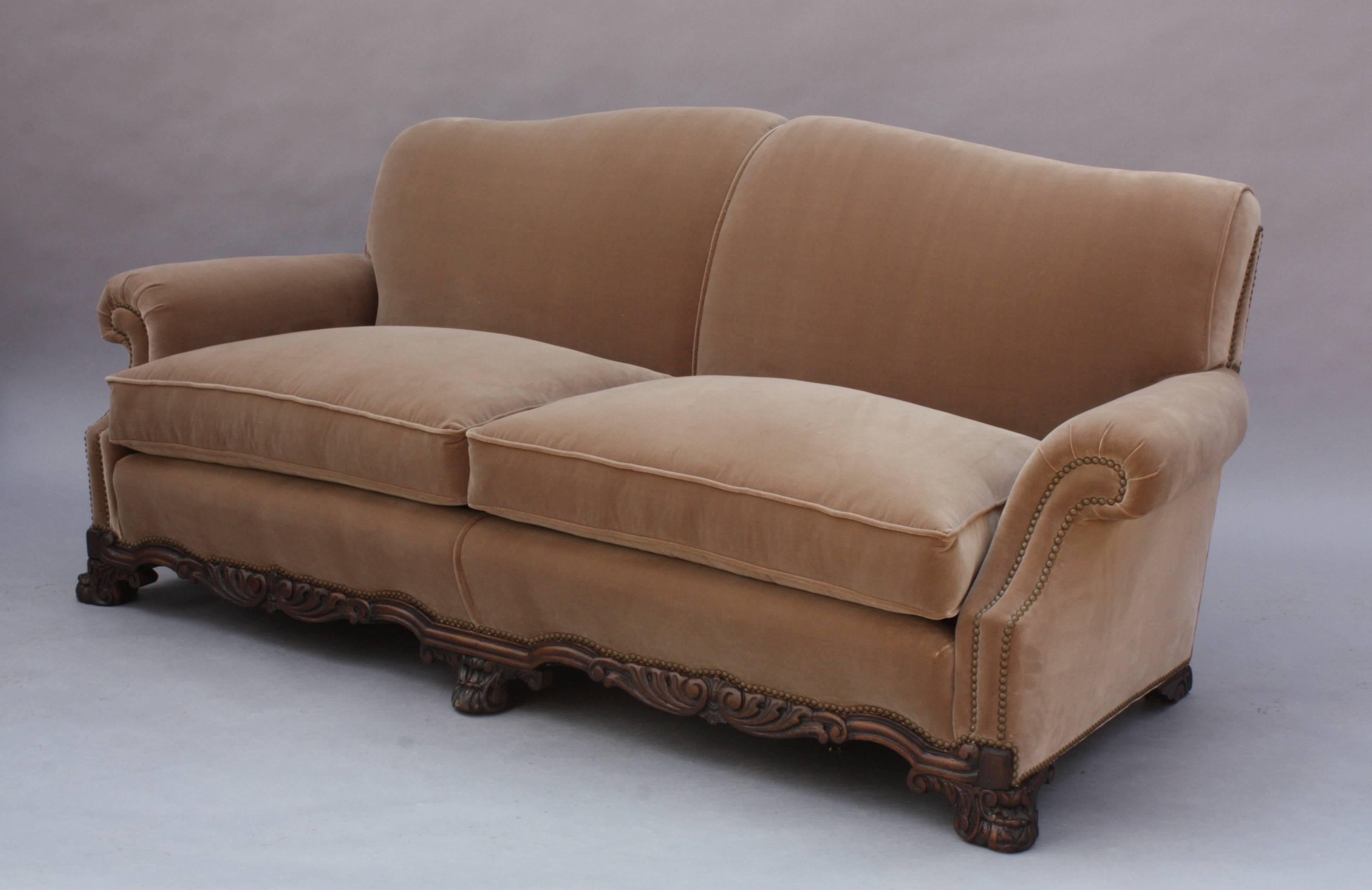 Classic 1920s carved sofa newly upholstered in velvet. Coordinates with chair.