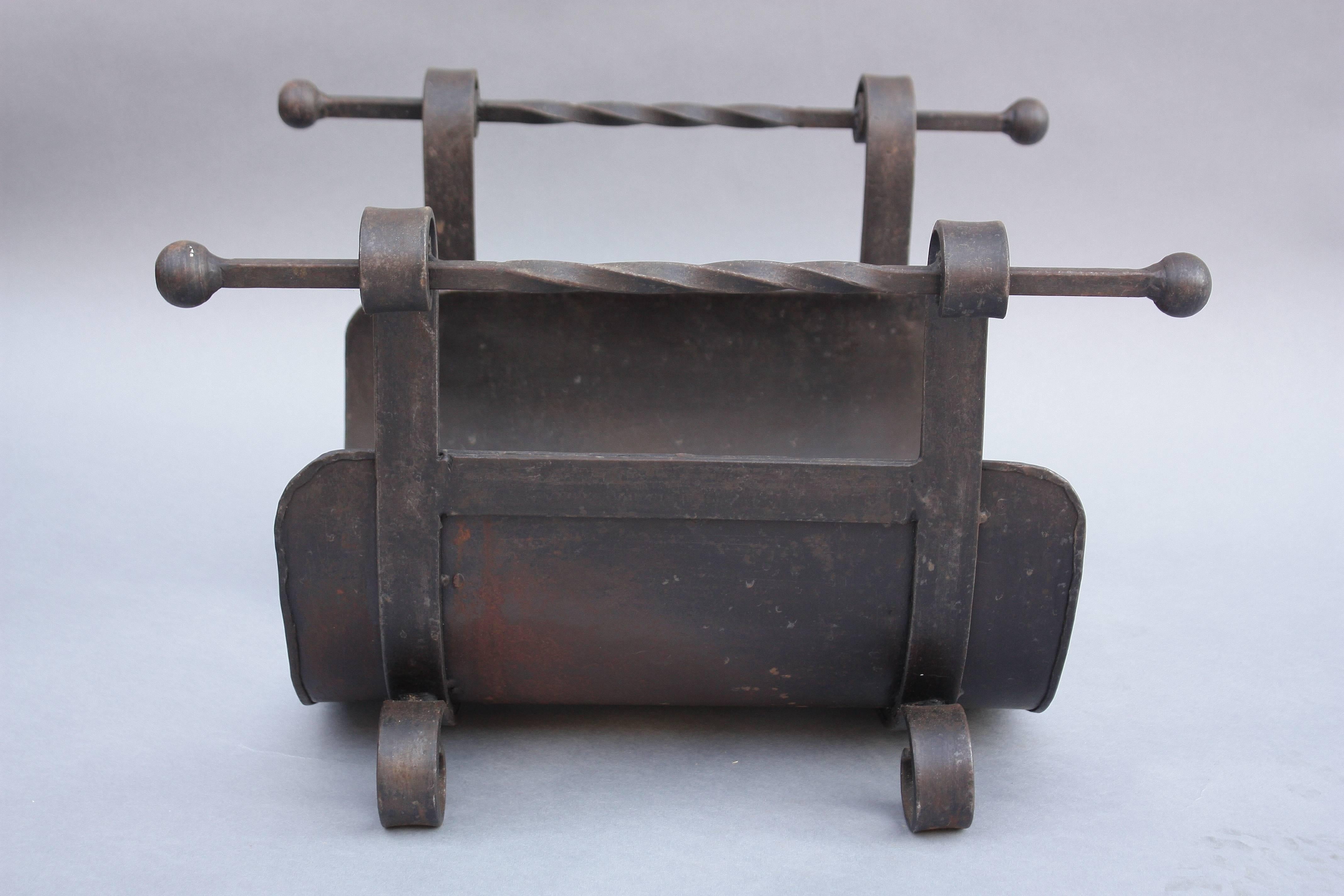 Handsome wrought iron log holder from the 1920s.