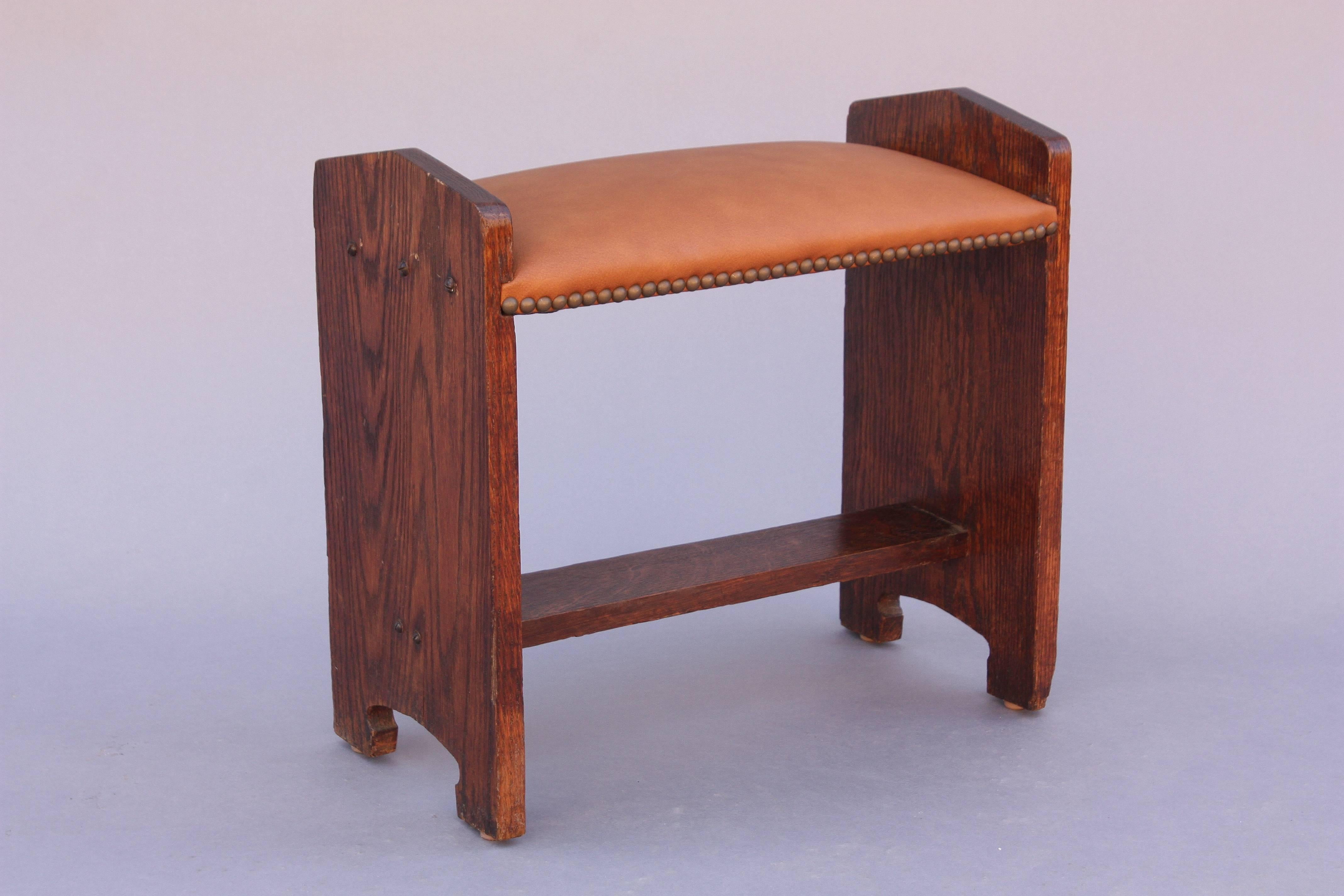 Oak foot stool with new leather upholstery, circa 1910.