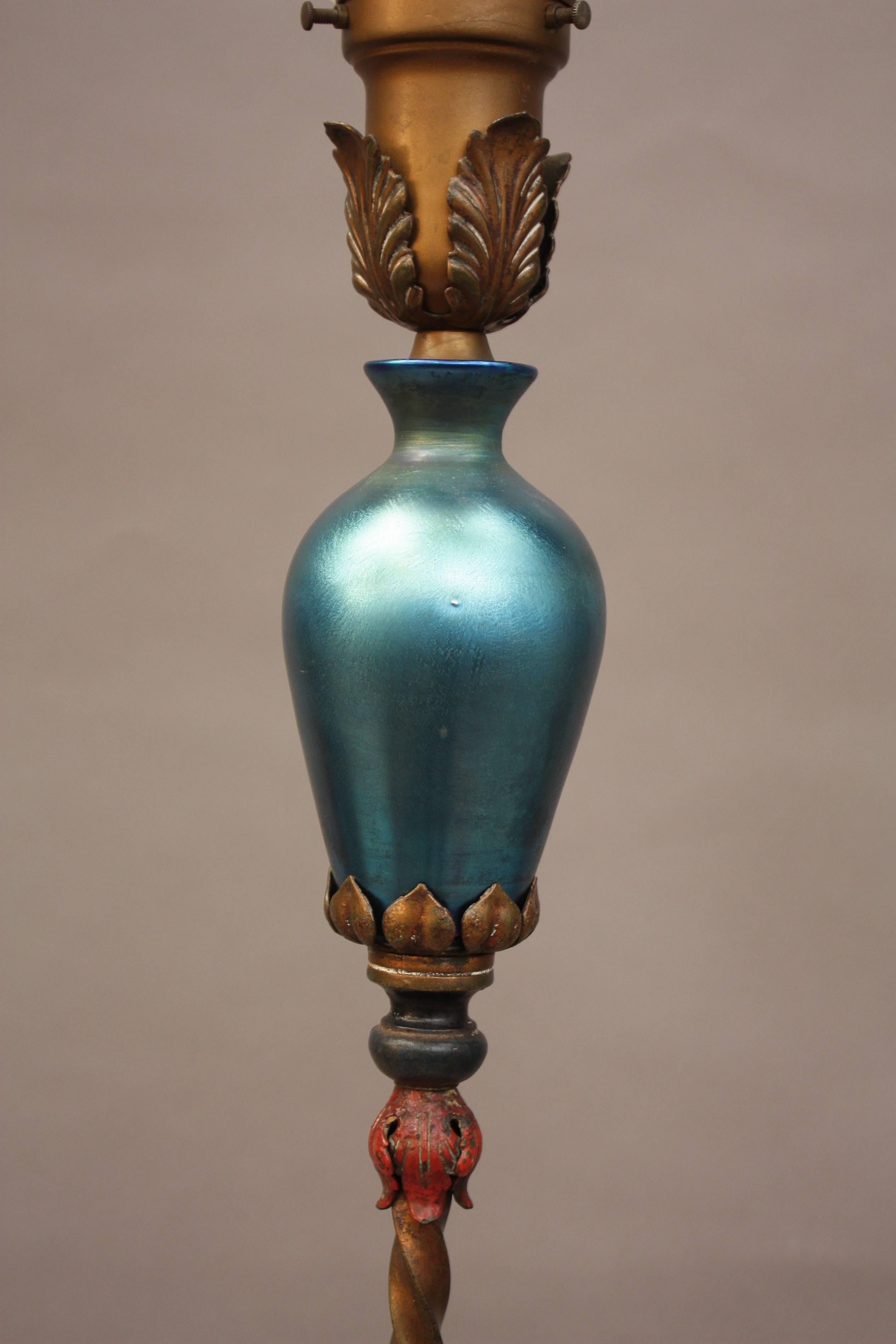 Fantastic 1920s lamp with blue Steuben vase insert and original polychrome base. Measures: 56