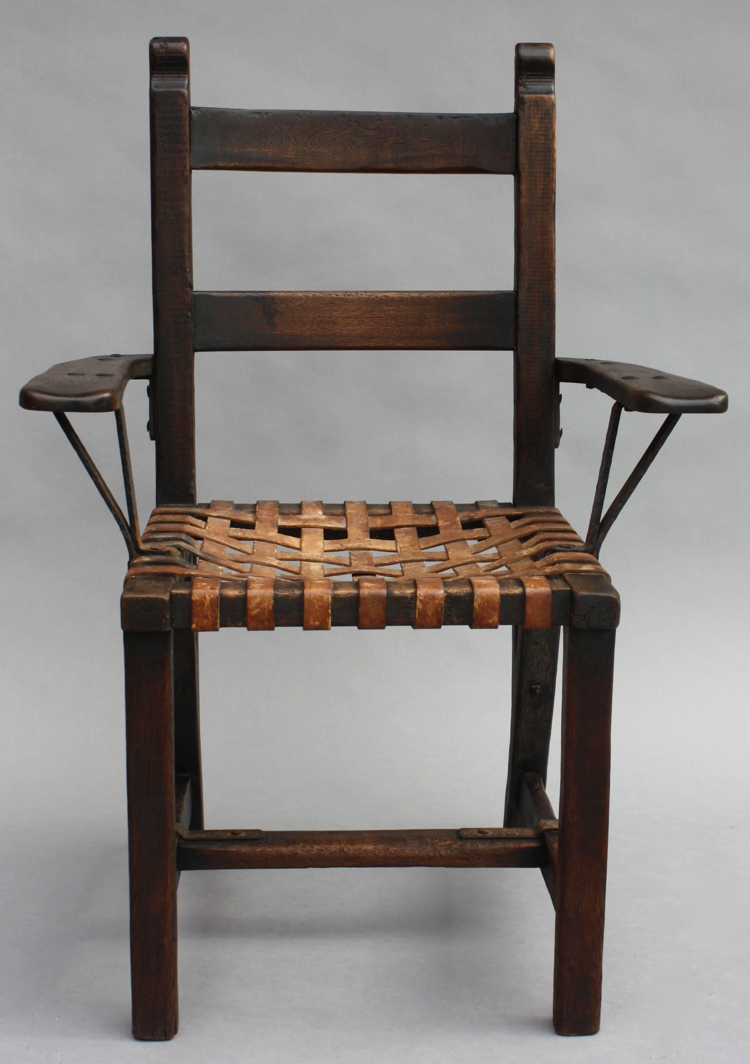 Wonderful Monterey period chair with original woven leather strap seat and iron strapping.