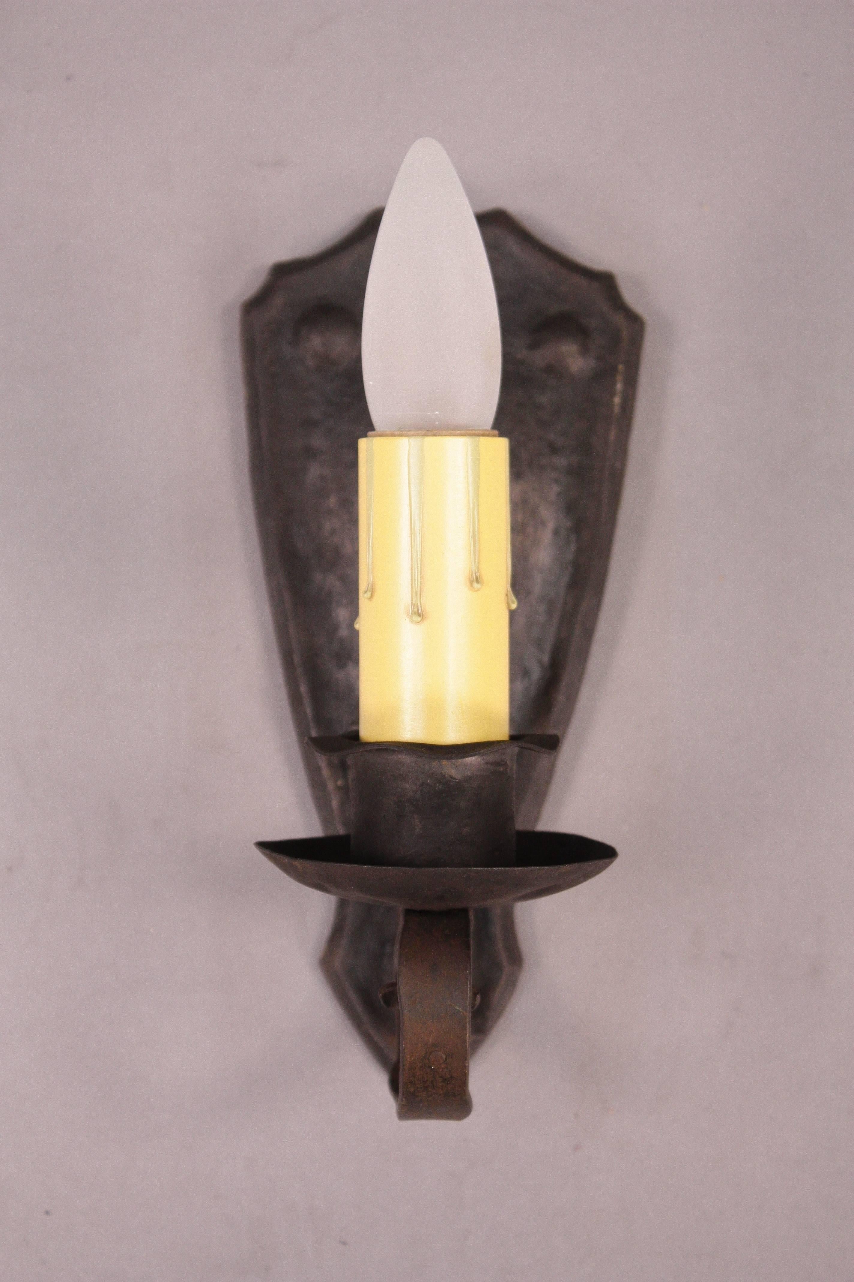 Sold and priced individually. Single sconce with wrought iron construction, circa 1920s. Measures: 12" H x 6" W x 5.25" D.